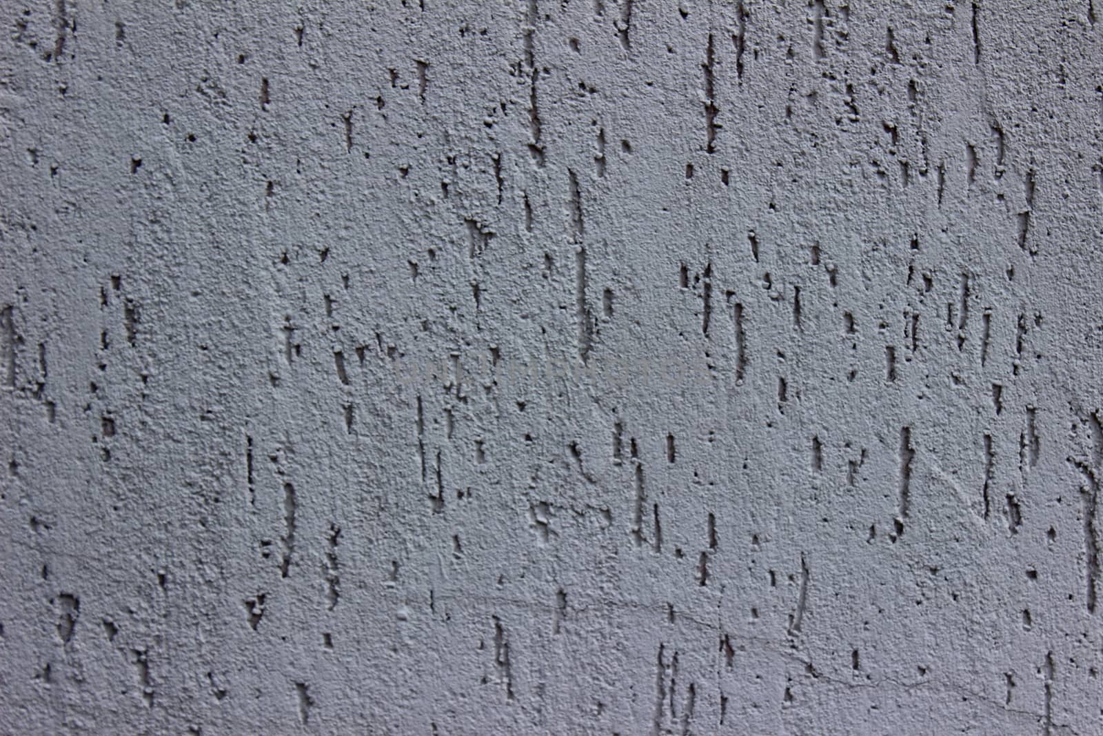 Gray wall of the building in order decor covered in scratches