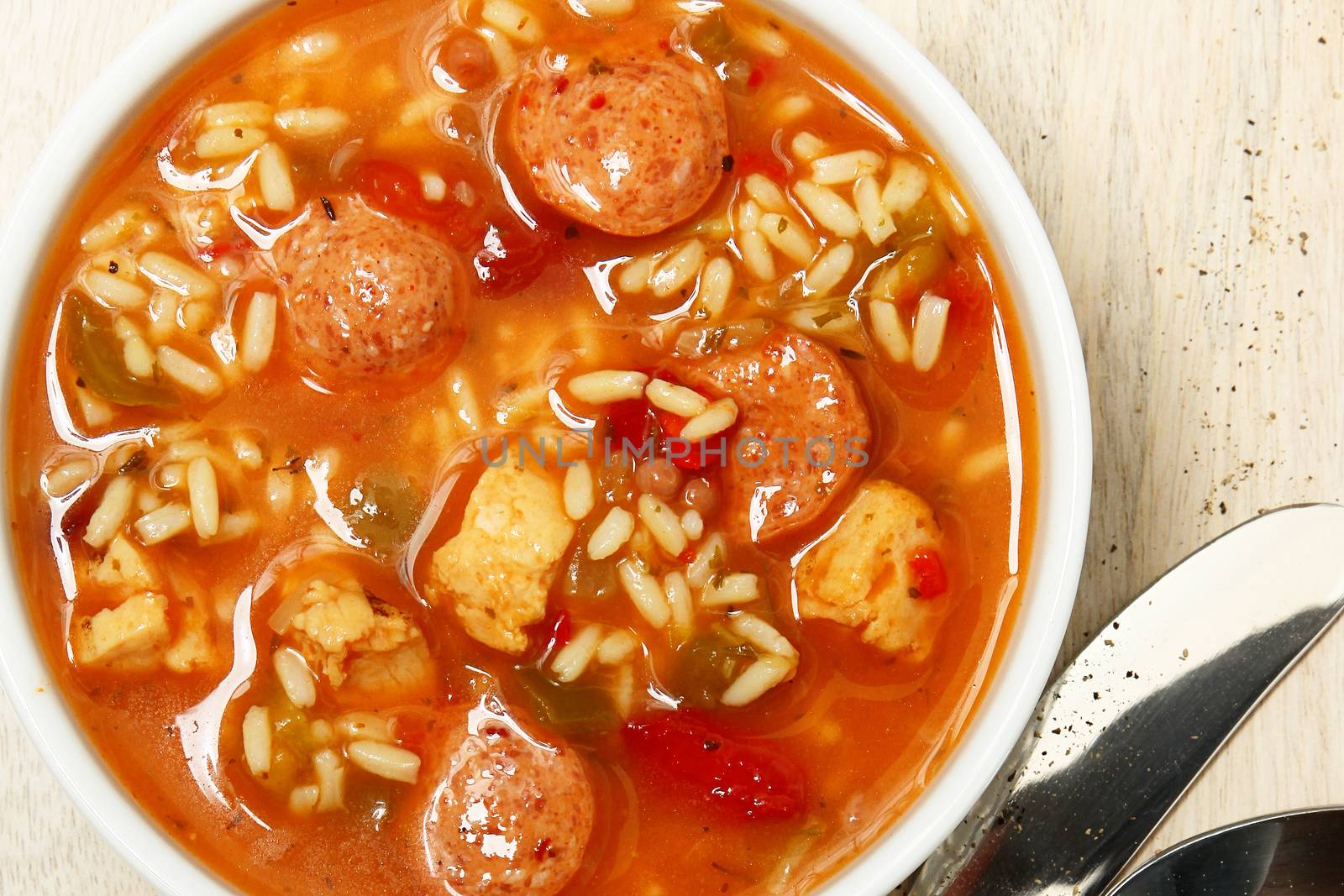 Bowl of Cajun Spicy Chicken and Sausage Gumbo Soup at Table