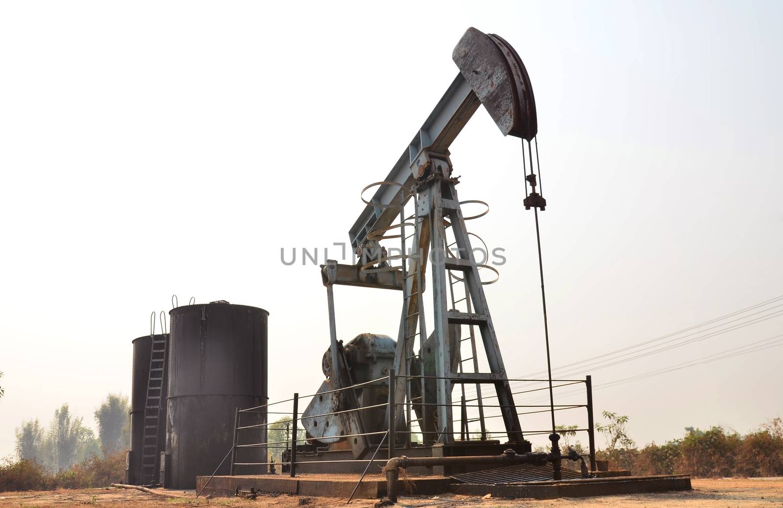old pumpjack pumping crude oil from oil well