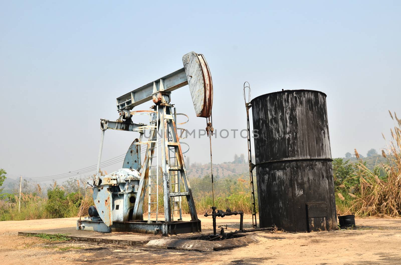 old pumpjack pumping crude oil from oil well
