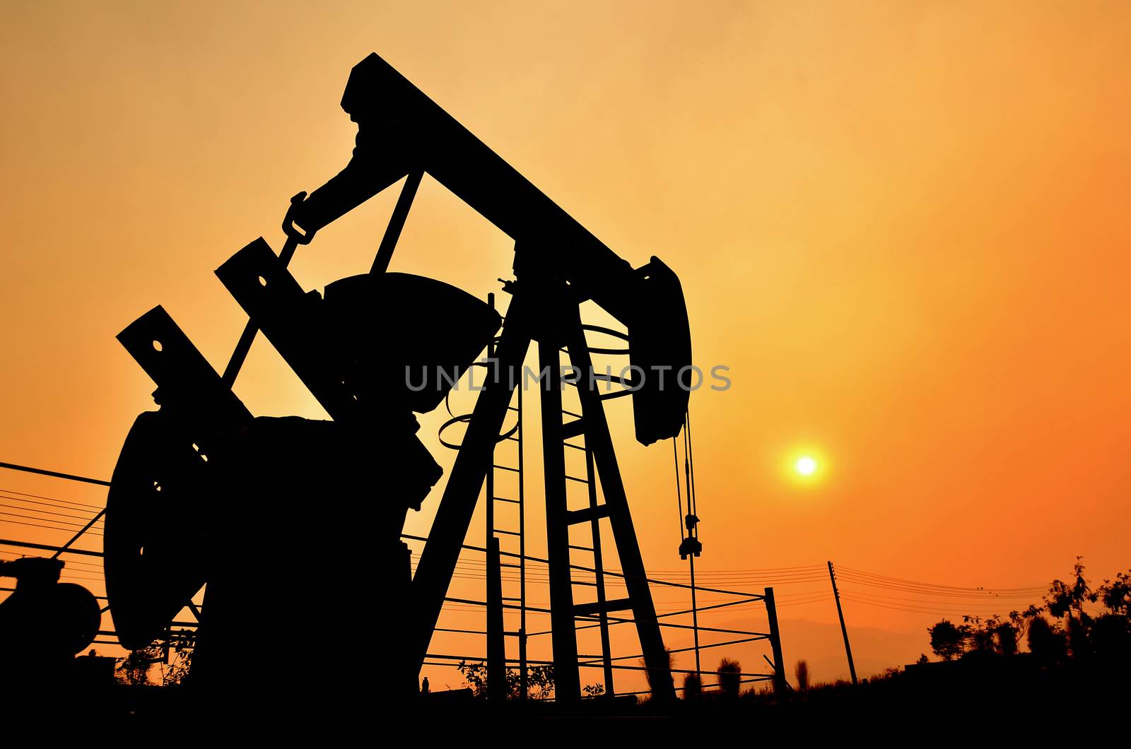 old pumpjack pumping crude oil from oil well