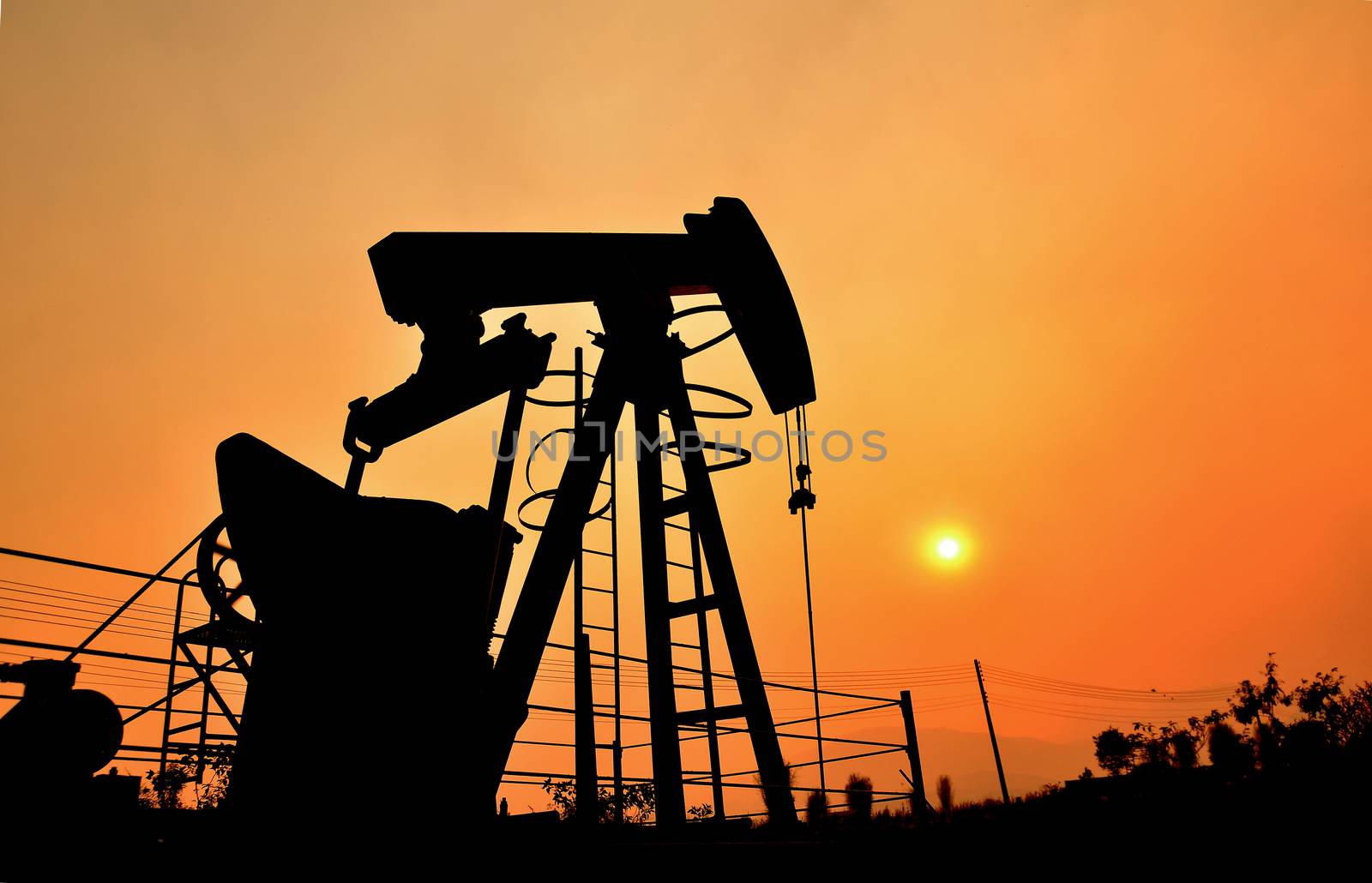 old pumpjack pumping crude oil from oil well