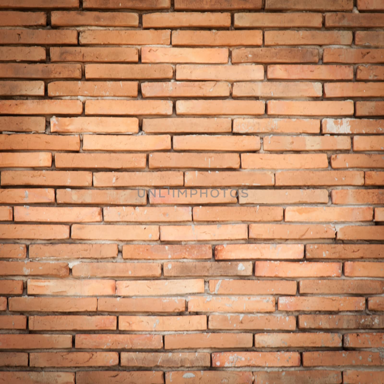 Old brick wall forming a old red brick wall. As a background