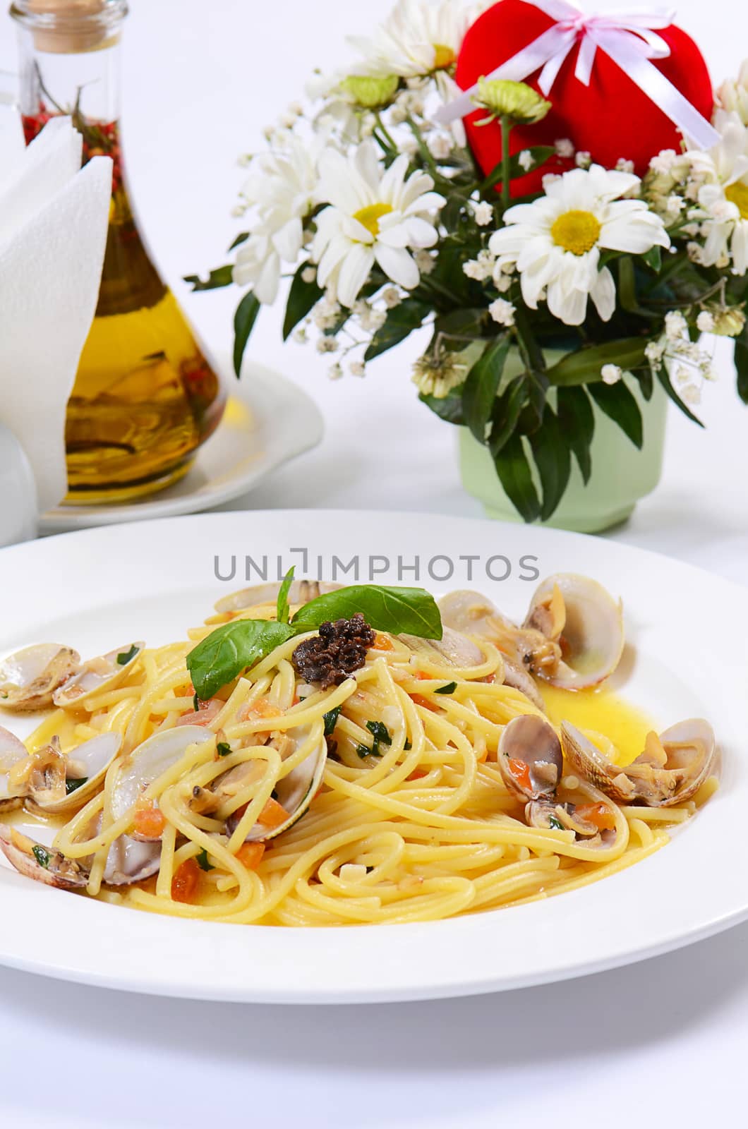 Spaghetti with mussels in bowls close up