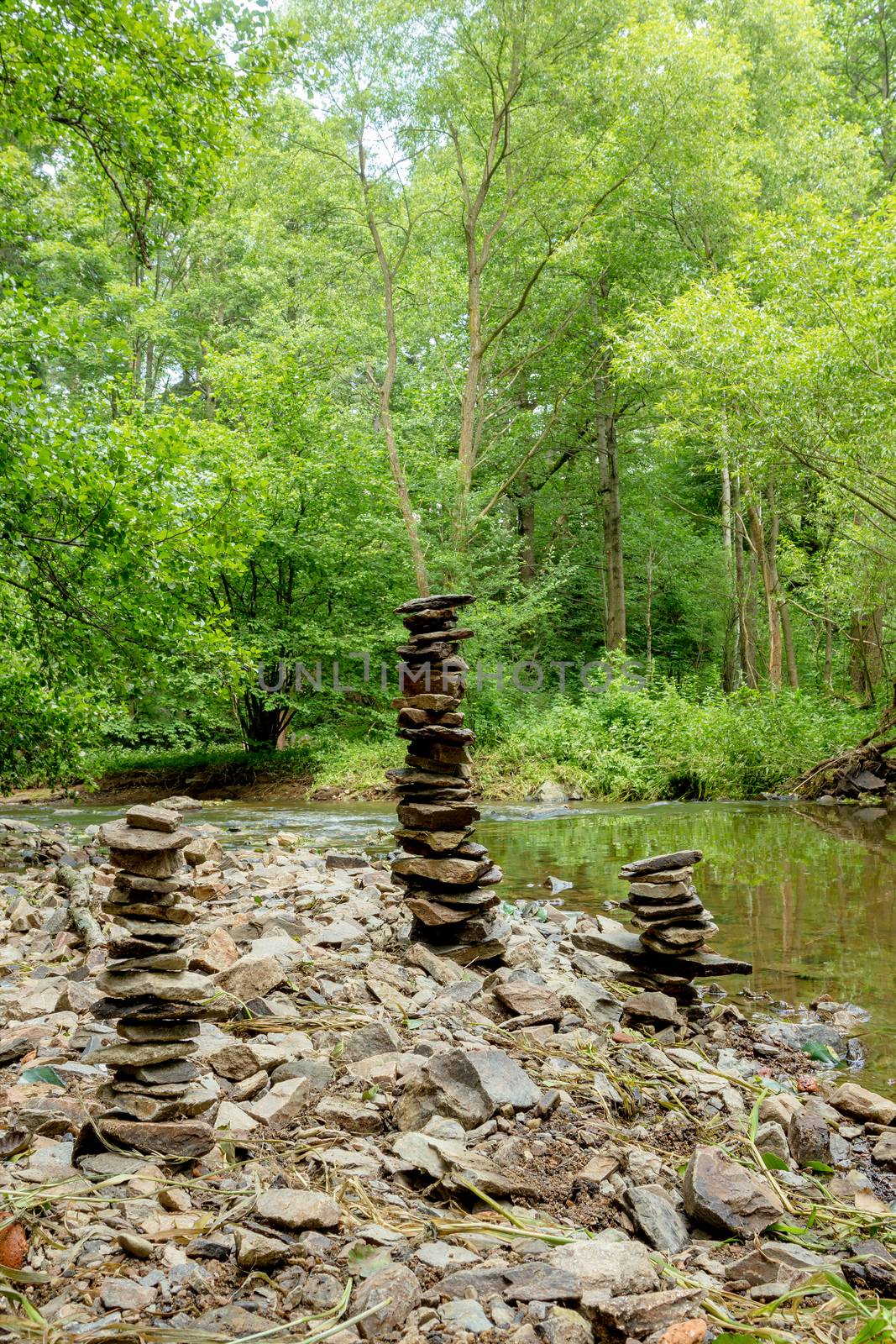 three Stones pyramid near small river symbolizing zen, harmony, balance