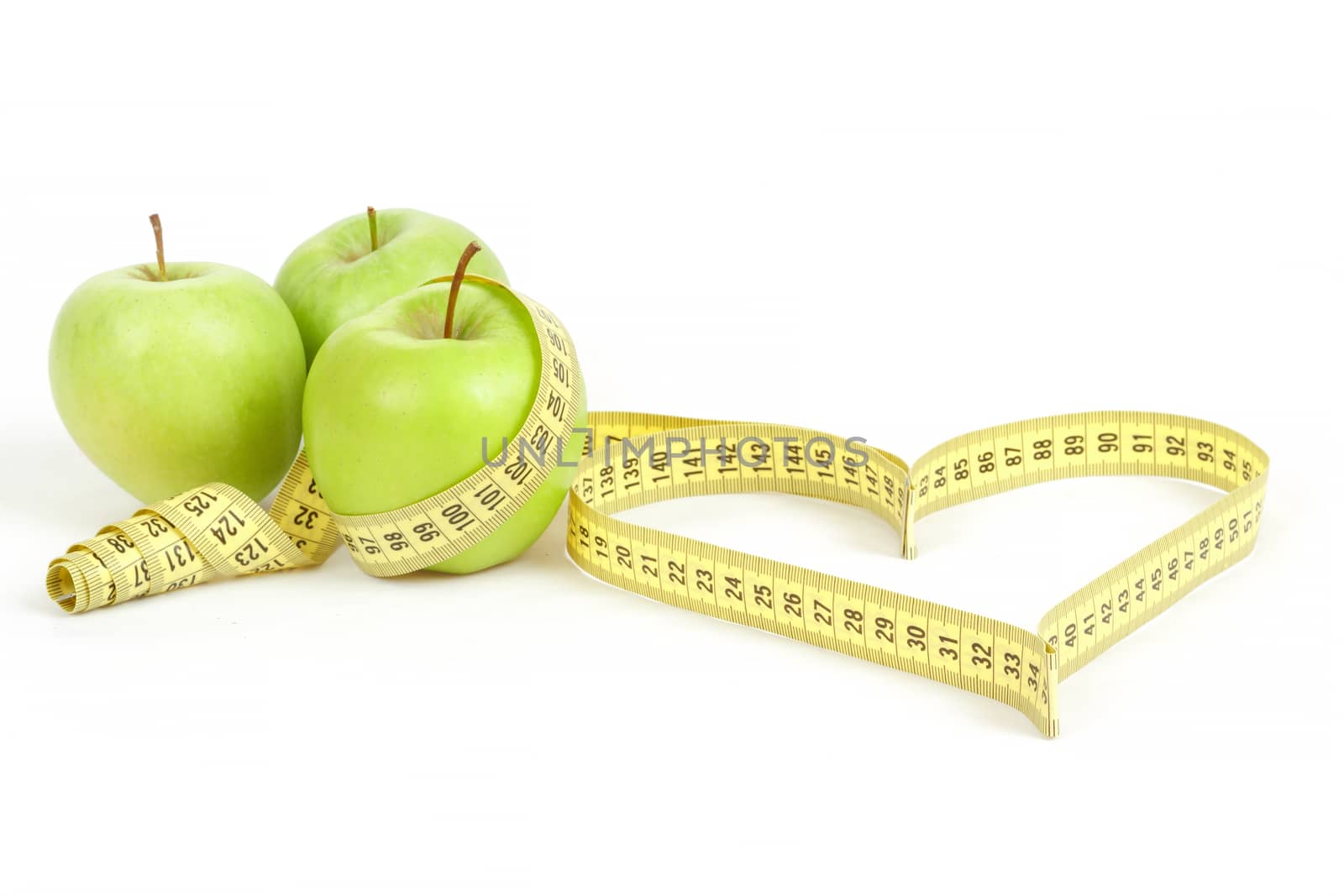 green apple with a measuring tape and heart symbol isolated on white background 