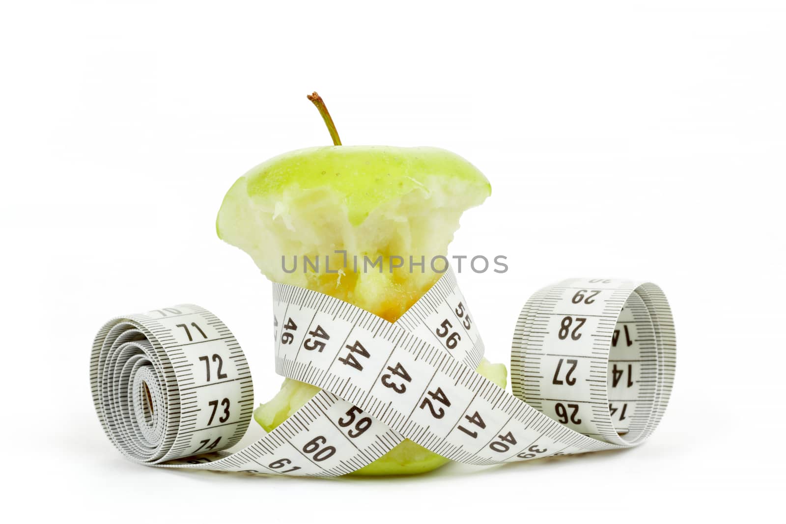 Green bitten apple isolated on white background with measuring tape