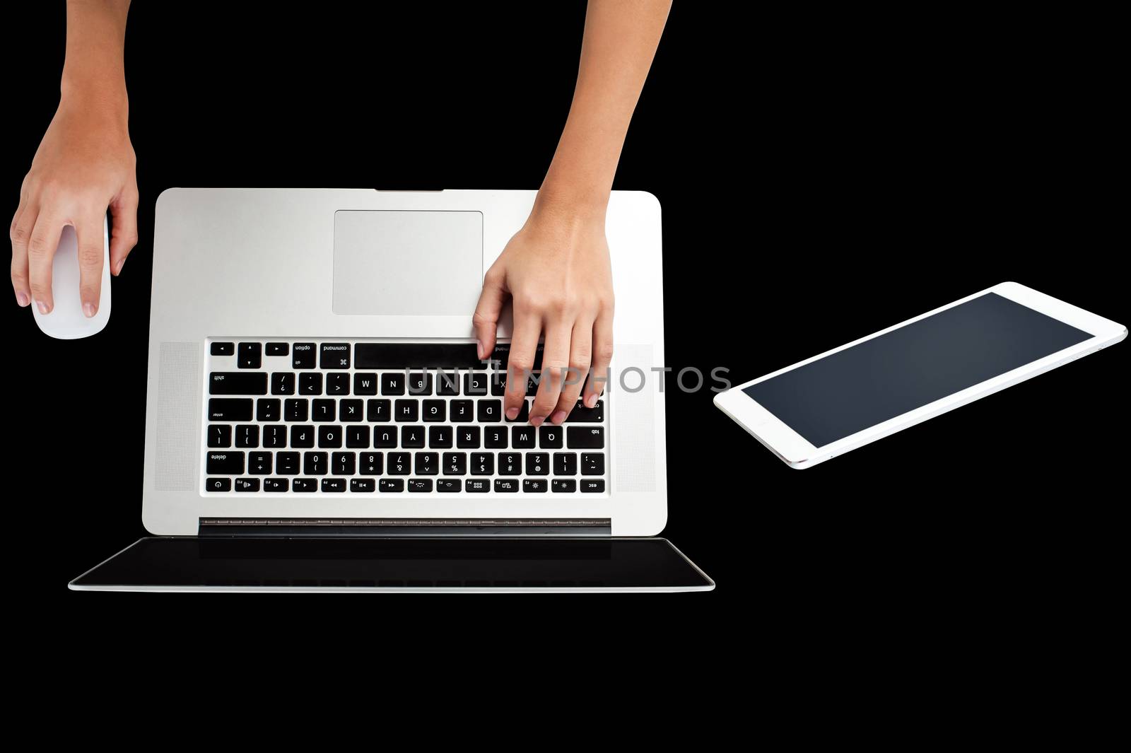 Female hands working on laptop, on black background