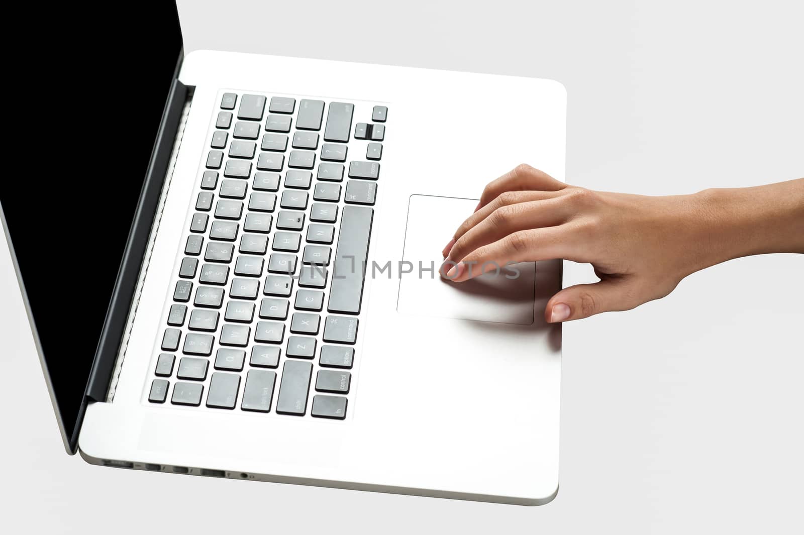 Hand operating a brand new laptop by stockyimages