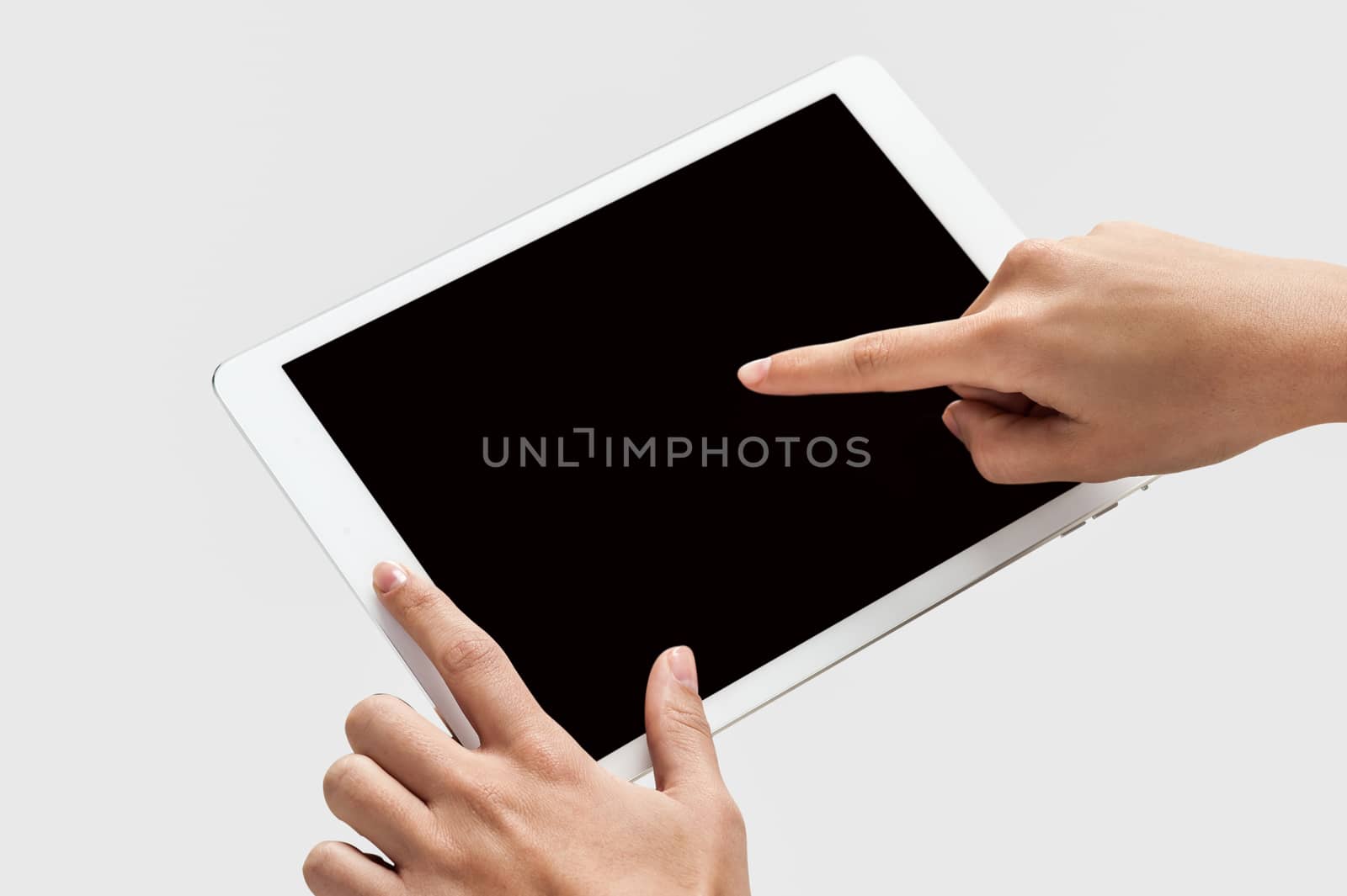 Finger being pointed on tablet screen by stockyimages