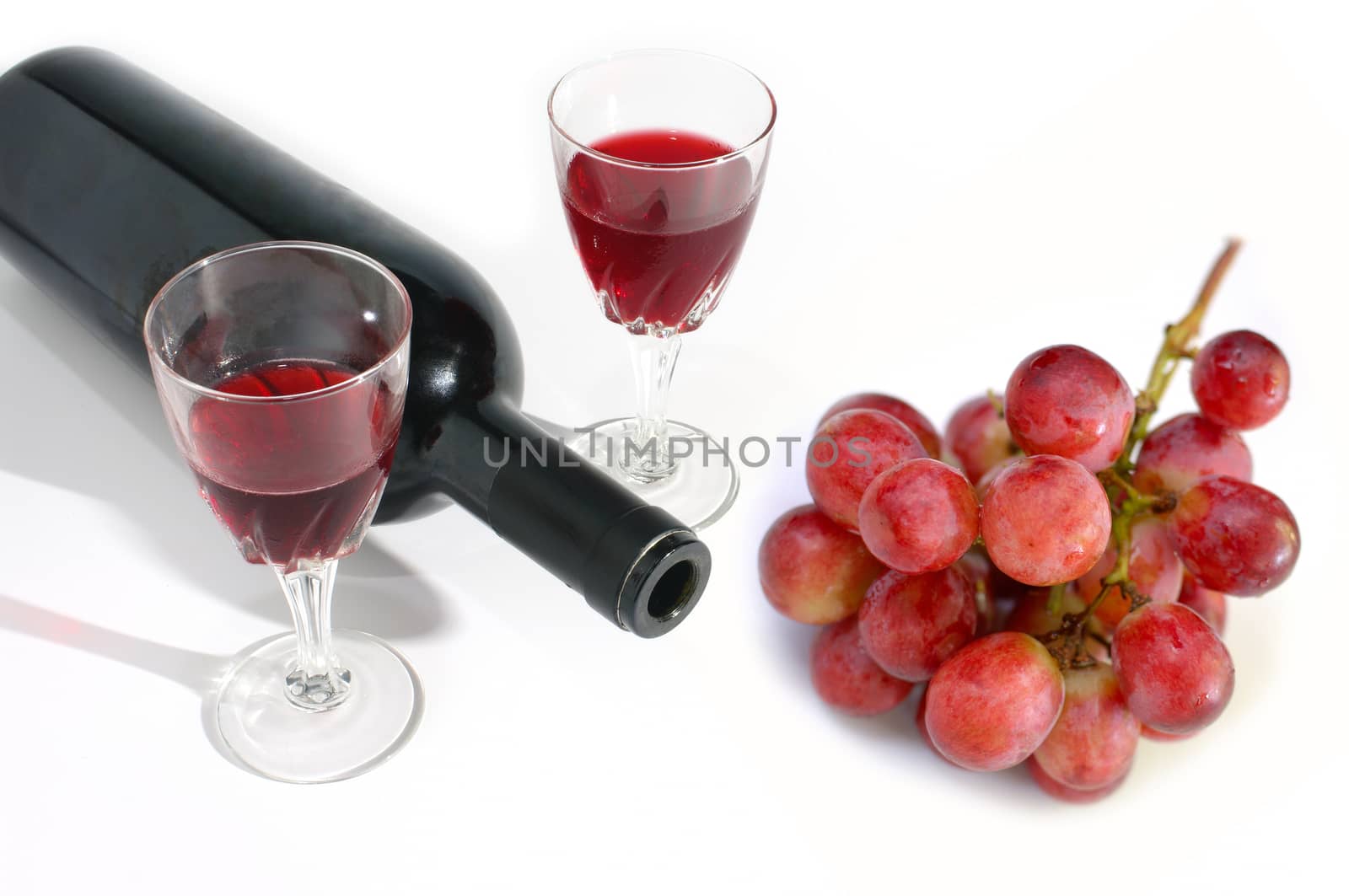 Wine glass and wine bottle with grape isolated on white background 