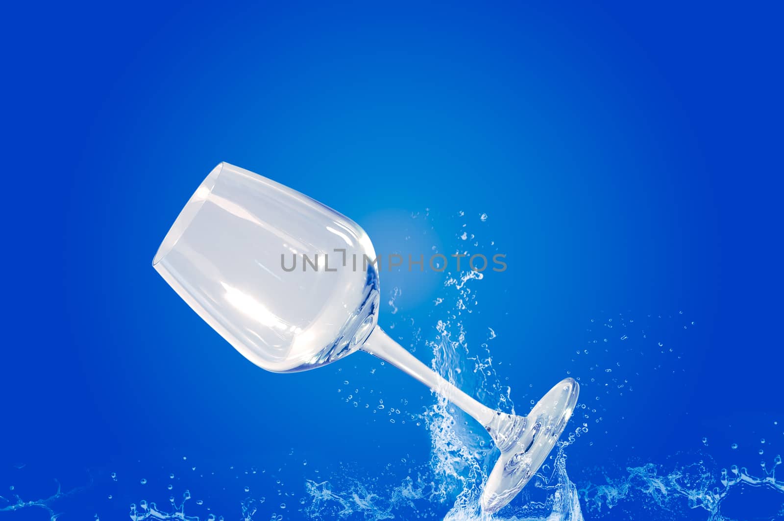 Wine glass fall in the water with a blue background