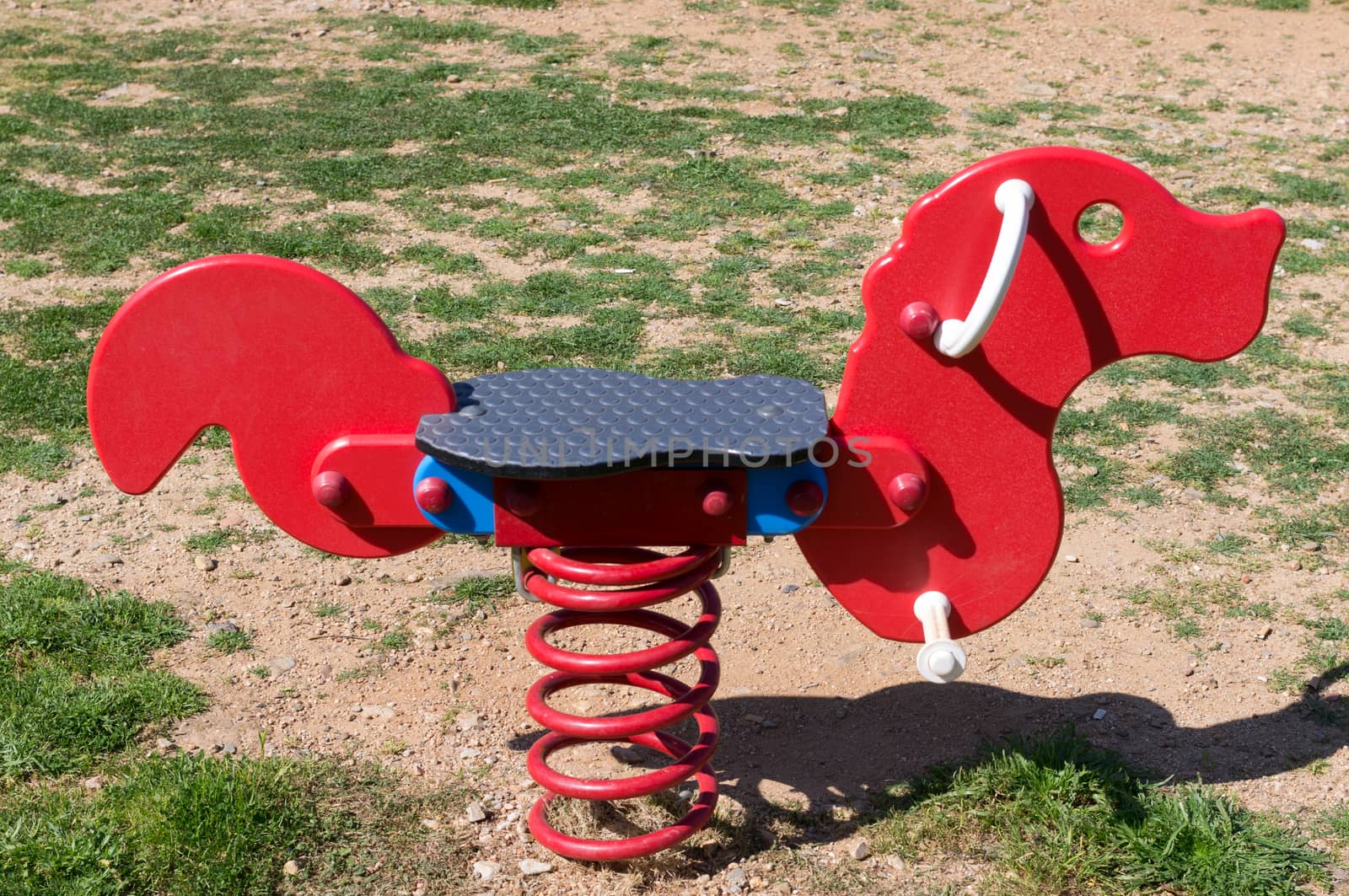 Detail of a playground: rocking horse for children.