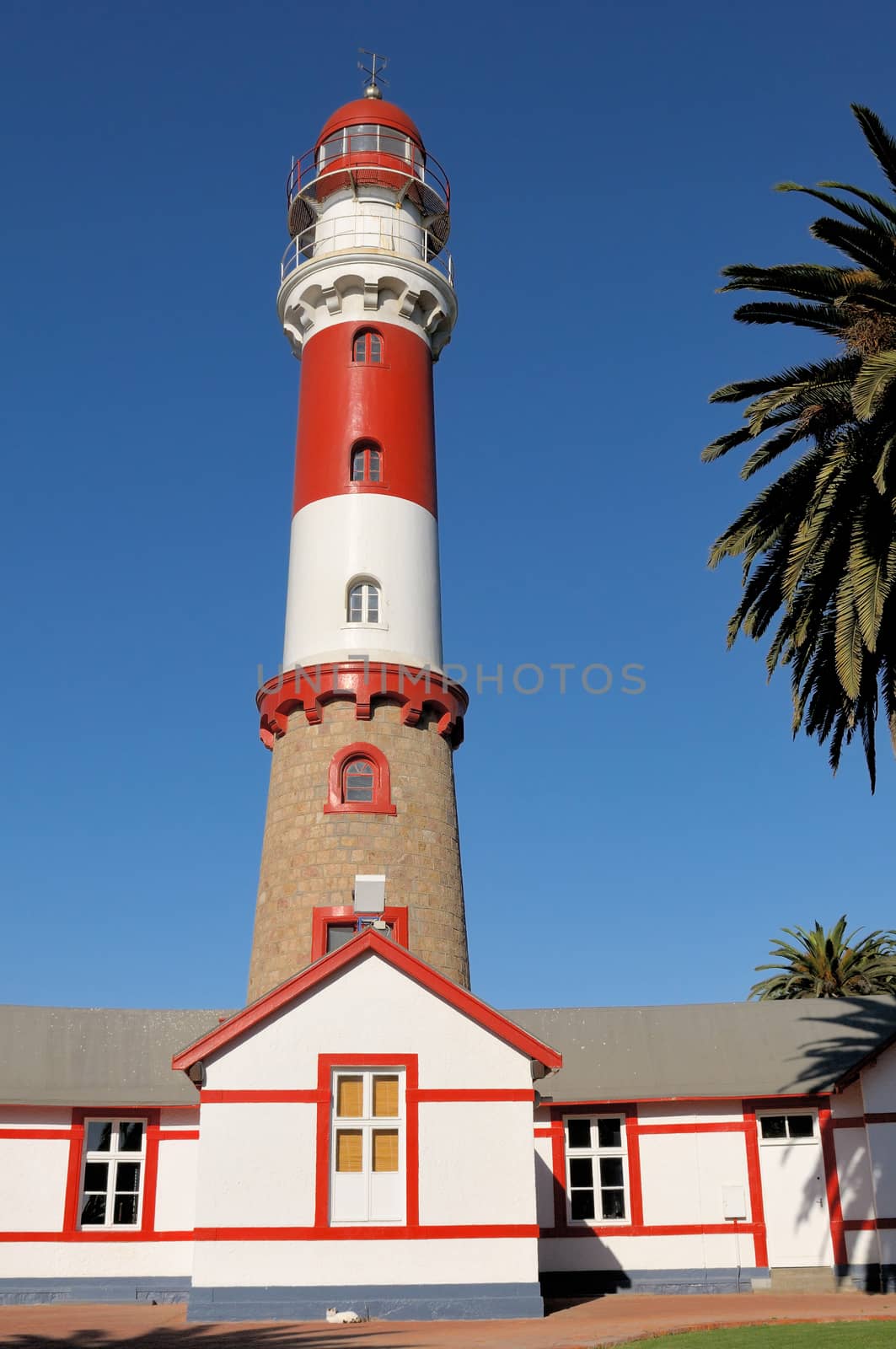 Historical lighthouse in Swakopmund, Namibia. Commissioned 1903,  It has a focal plane of 35 m (115 ft) with a 28 m (111 ft) round tower with lantern and double gallery.

