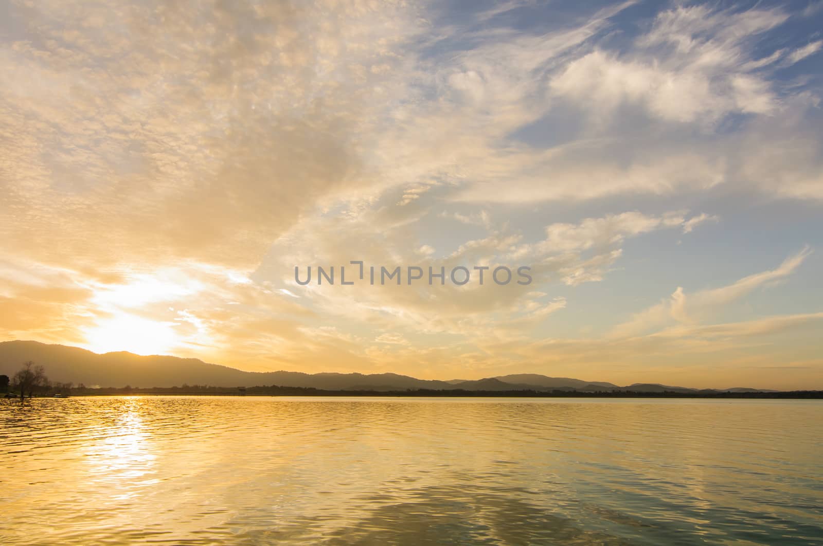 Sunrise on a lake  by Sorapop