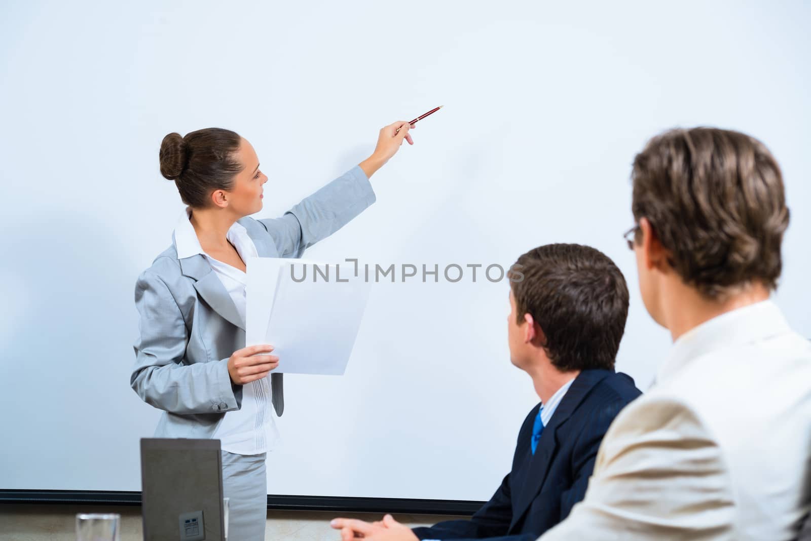 image of a Business woman showing a presentation to colleagues