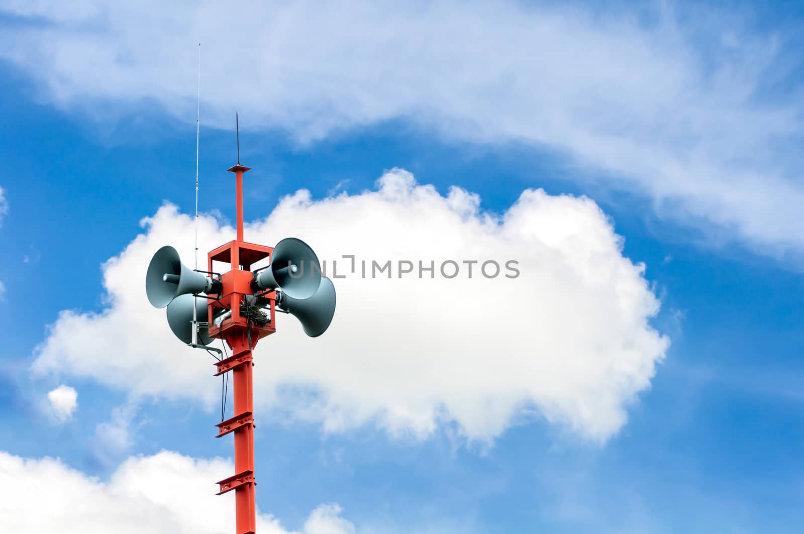 loudspeakers broadcasting and cloud background