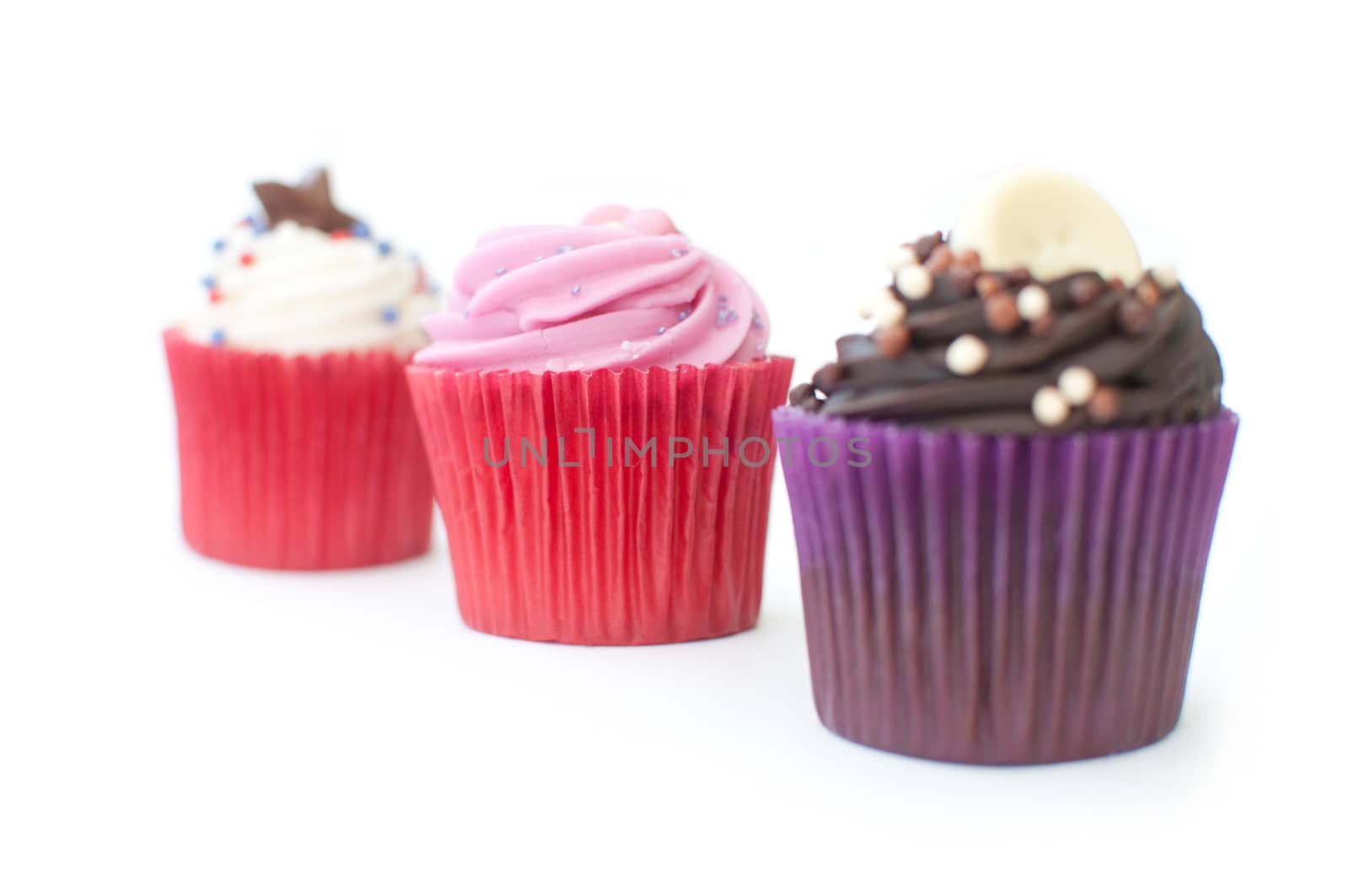 Delicious cream cupcakes on a white background