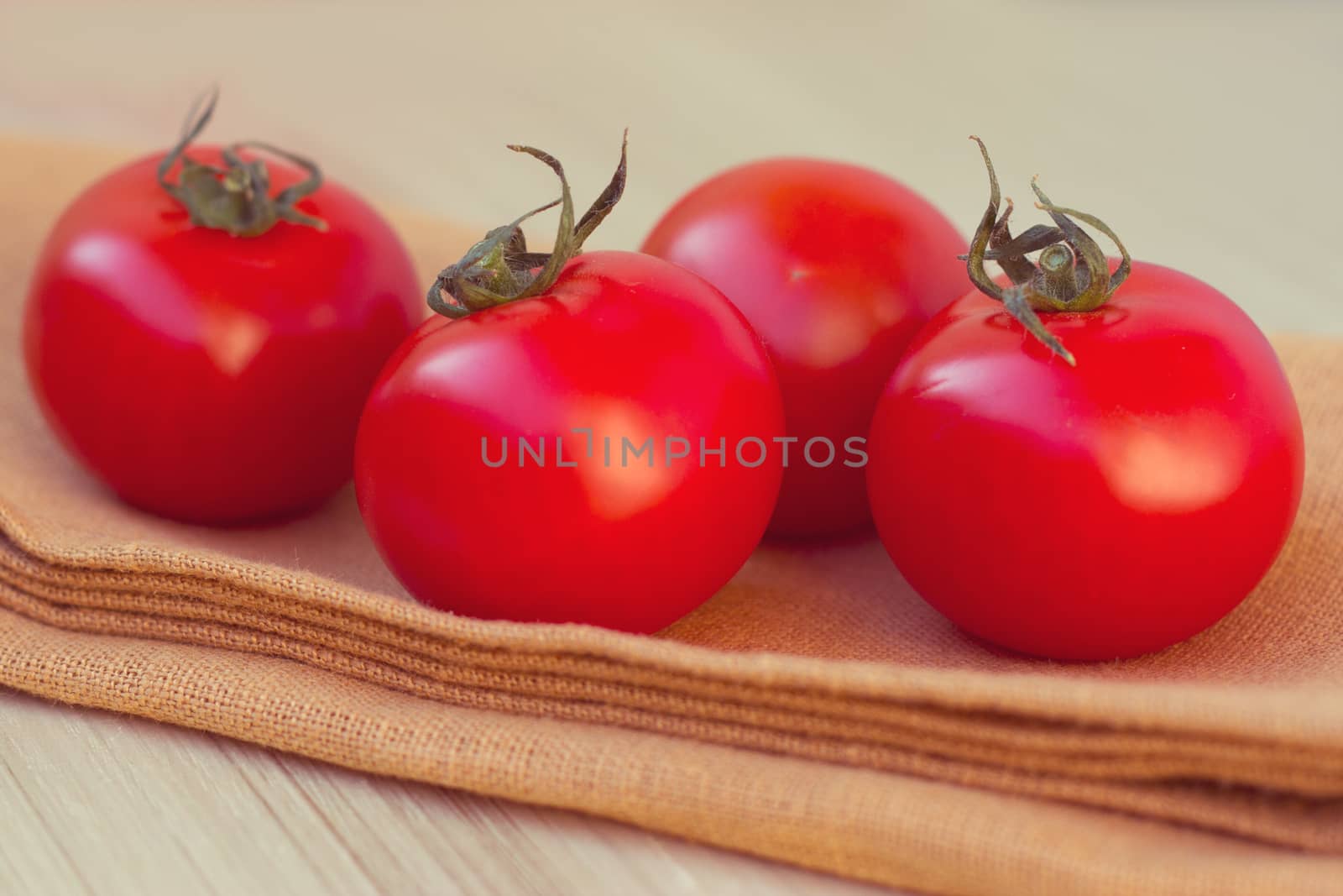 Fresh tomatoes on a wooden table top