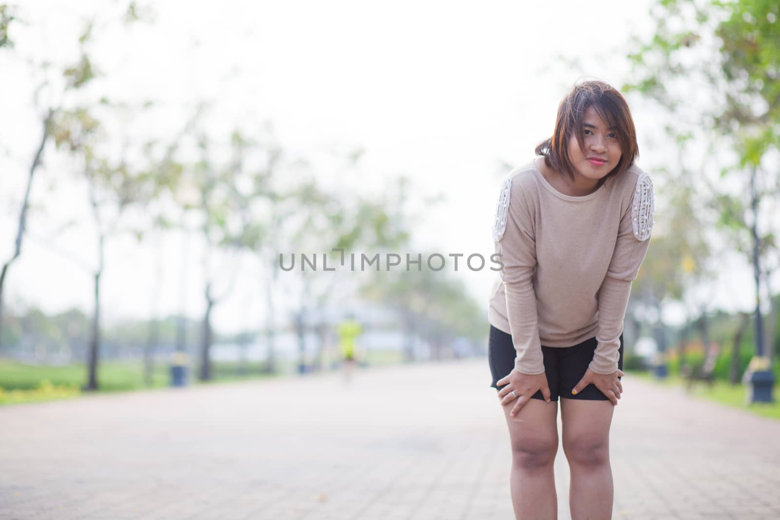 Portrait Asian woman in a park. Relax and have fun in the park.