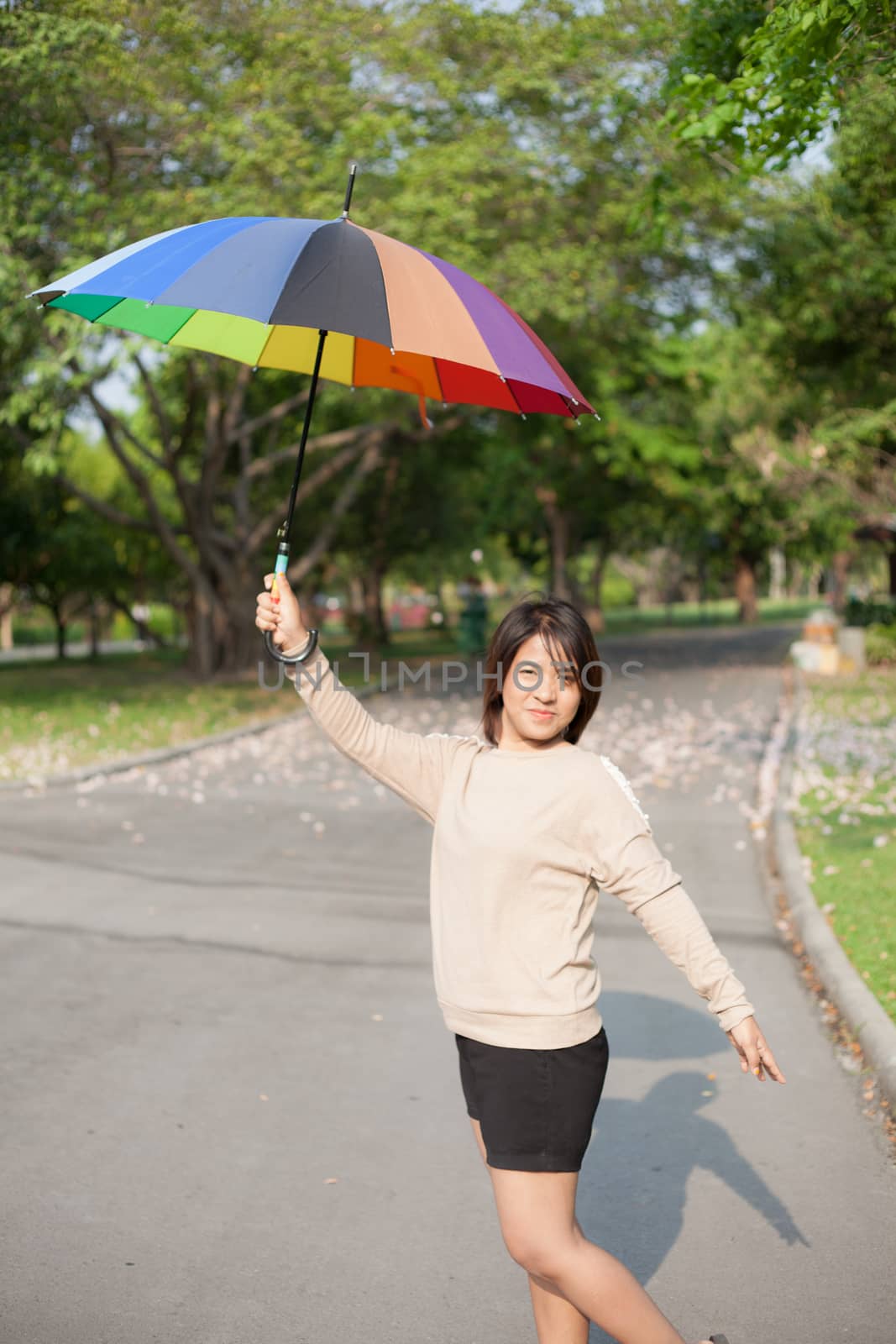 Women holding umbrella by a454