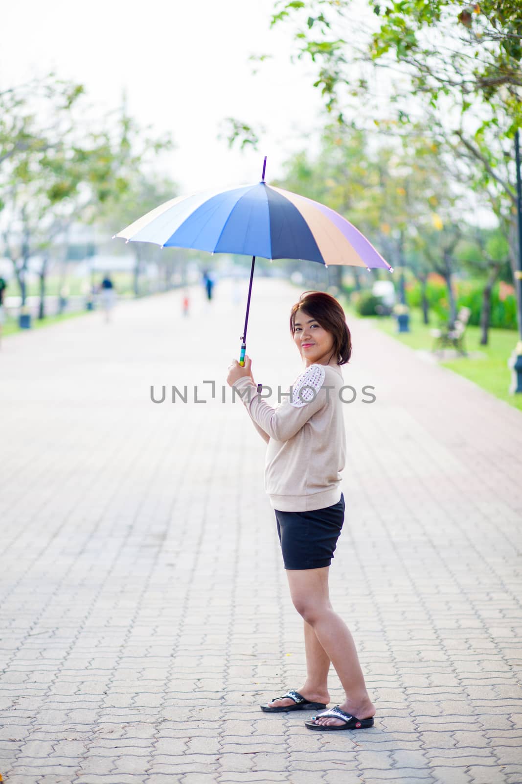 Portrait Asian woman holding an umbrella. by a454