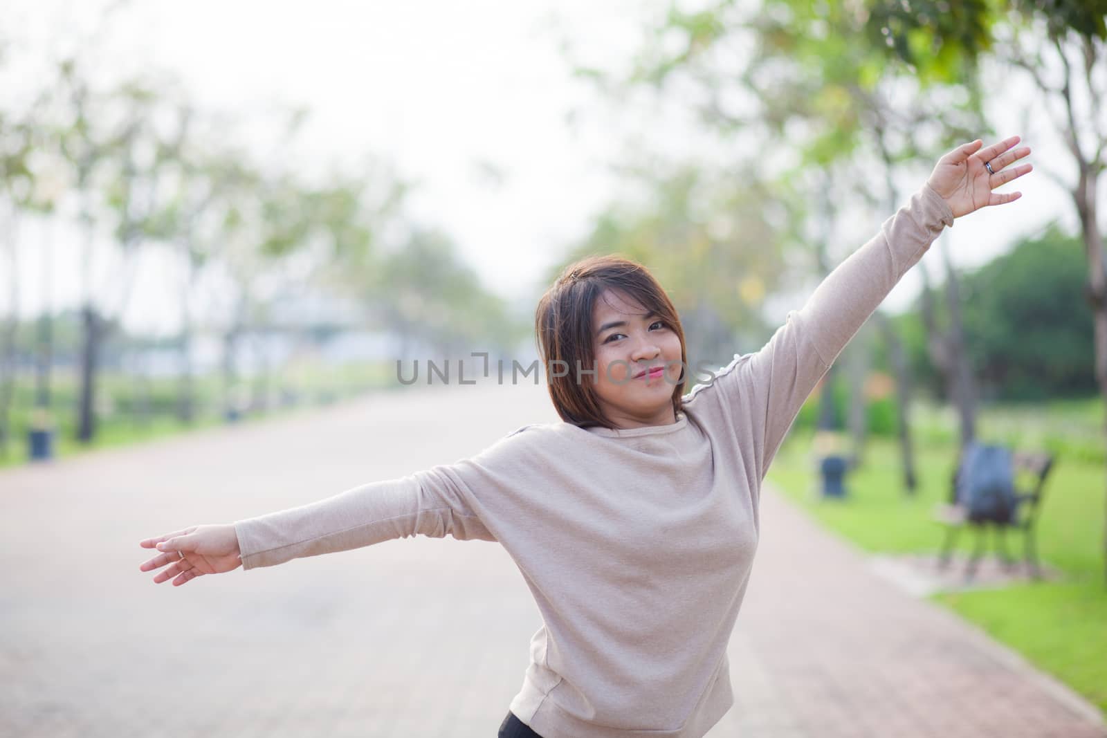Portrait Asian woman in a park. Relax and have fun in the park.
