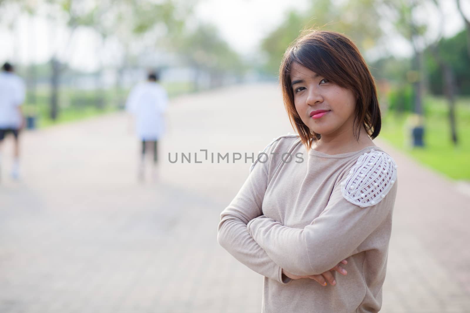 portrait asian woman standing in park.relax and smile woman in park.