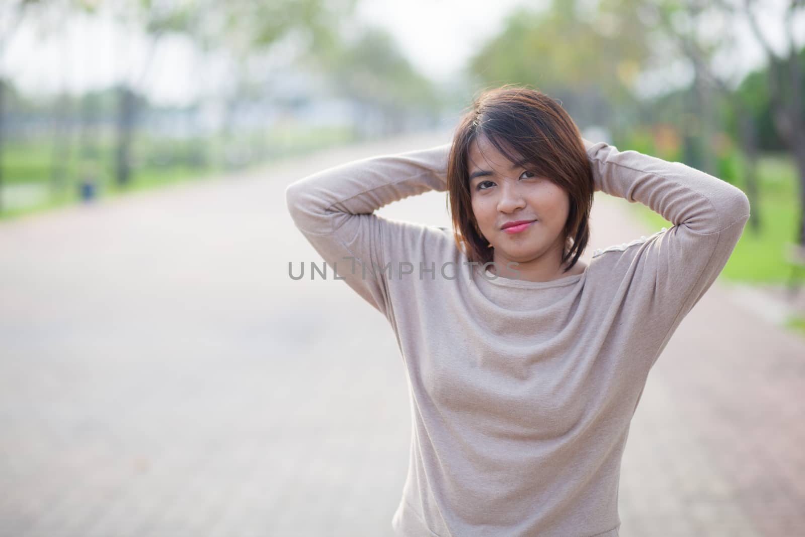 Portrait Asian woman in a park. Relax and have fun in the park.
