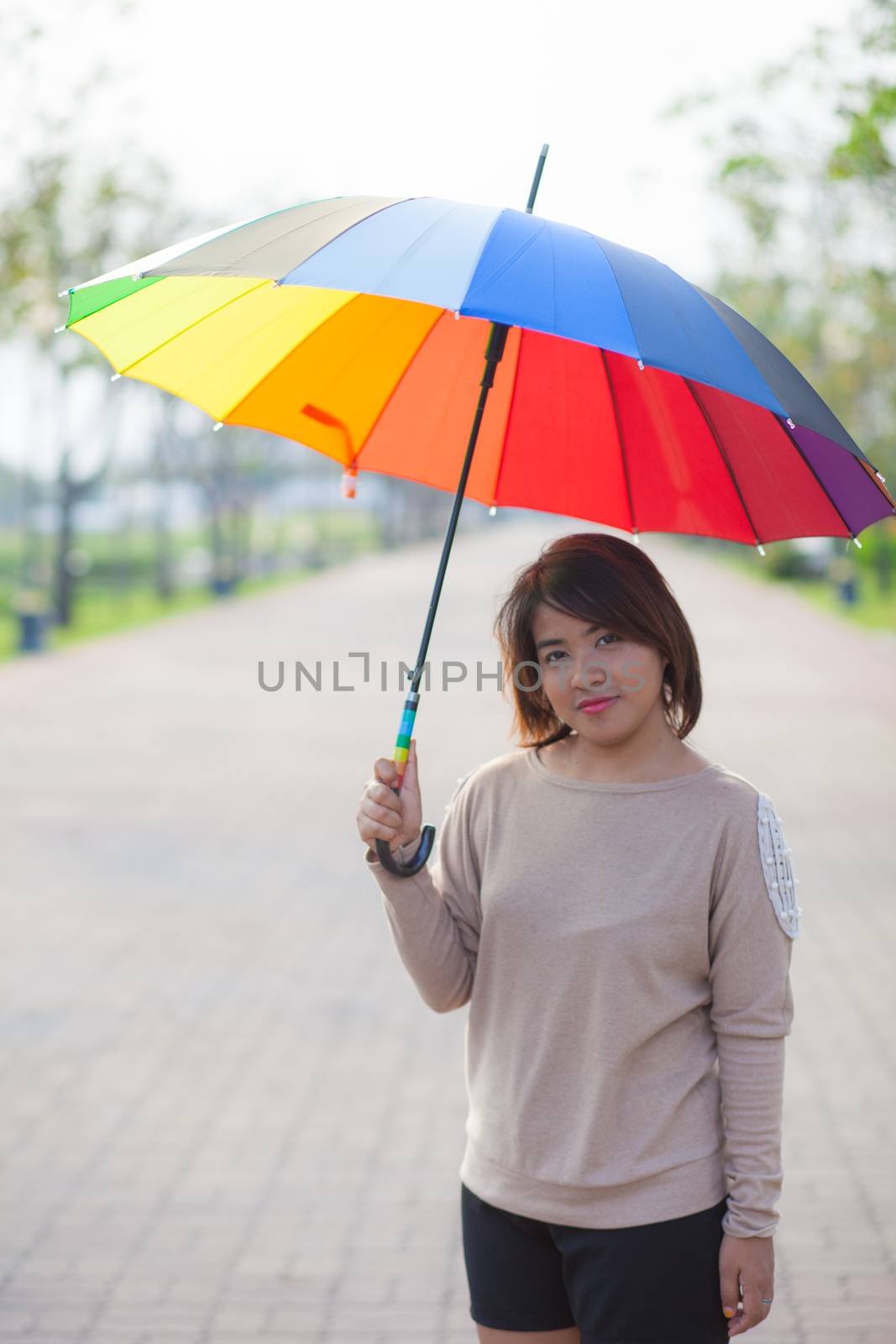 Woman holding an umbrella by a454
