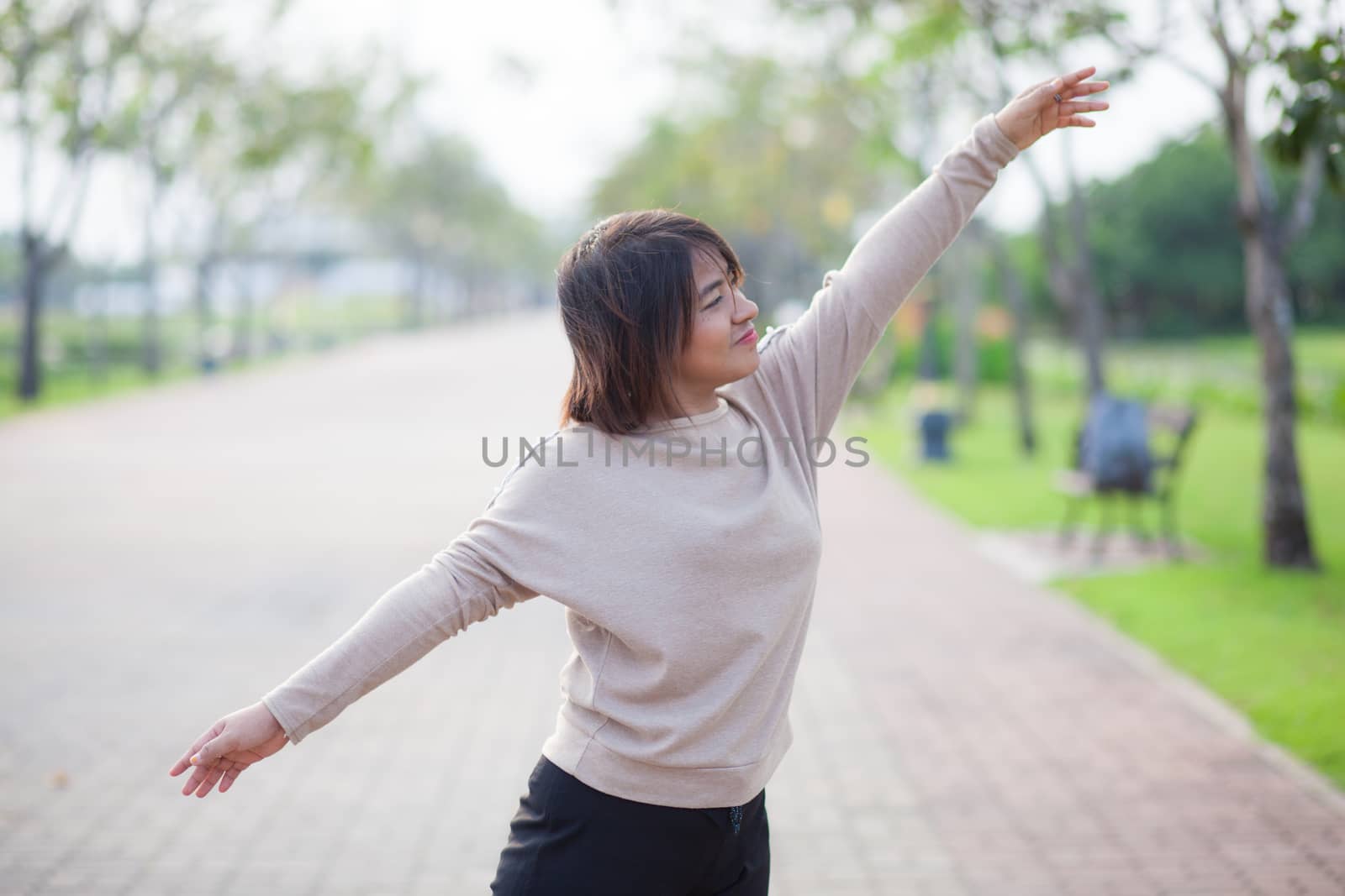 Portrait Asian woman in a park. Relax and have fun in the park.