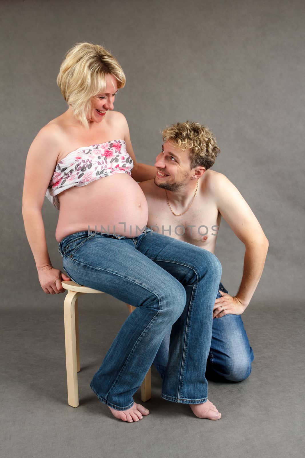 loving happy couple, smiling pregnant woman with her husband by artush