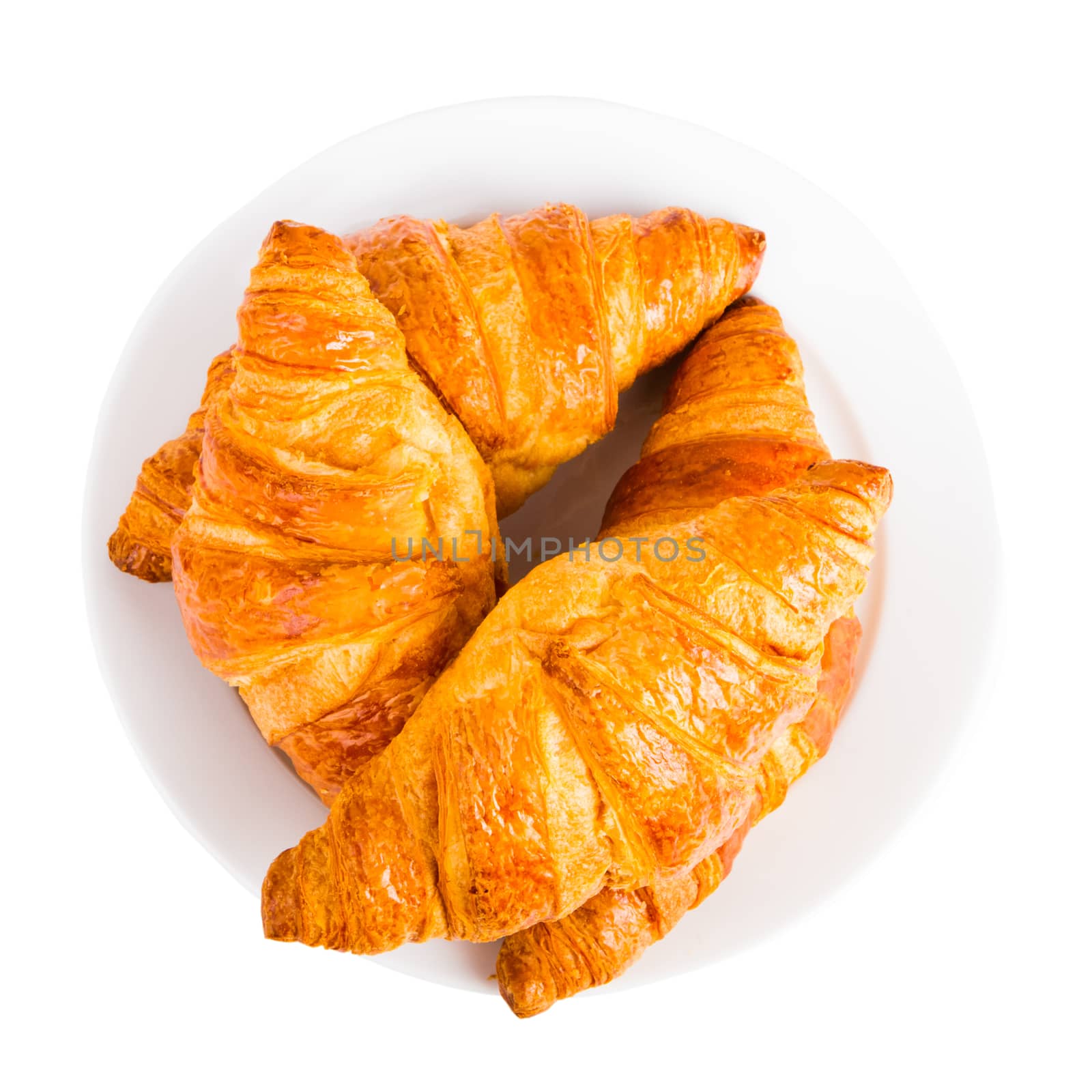 Croissants on a white plate isolated on white