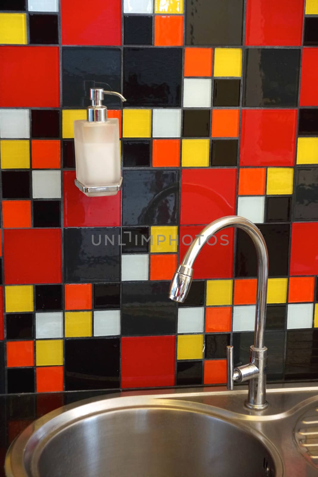 hand wash sink decorated with colourful mosaic tiles