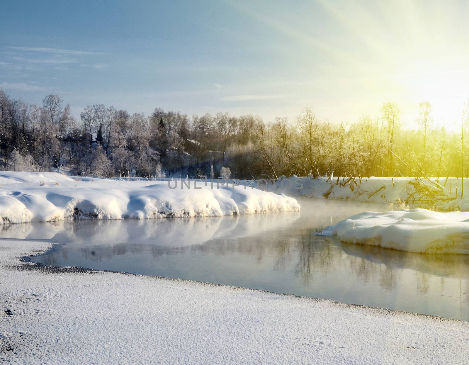 Winter landscape at dawn with river and sun