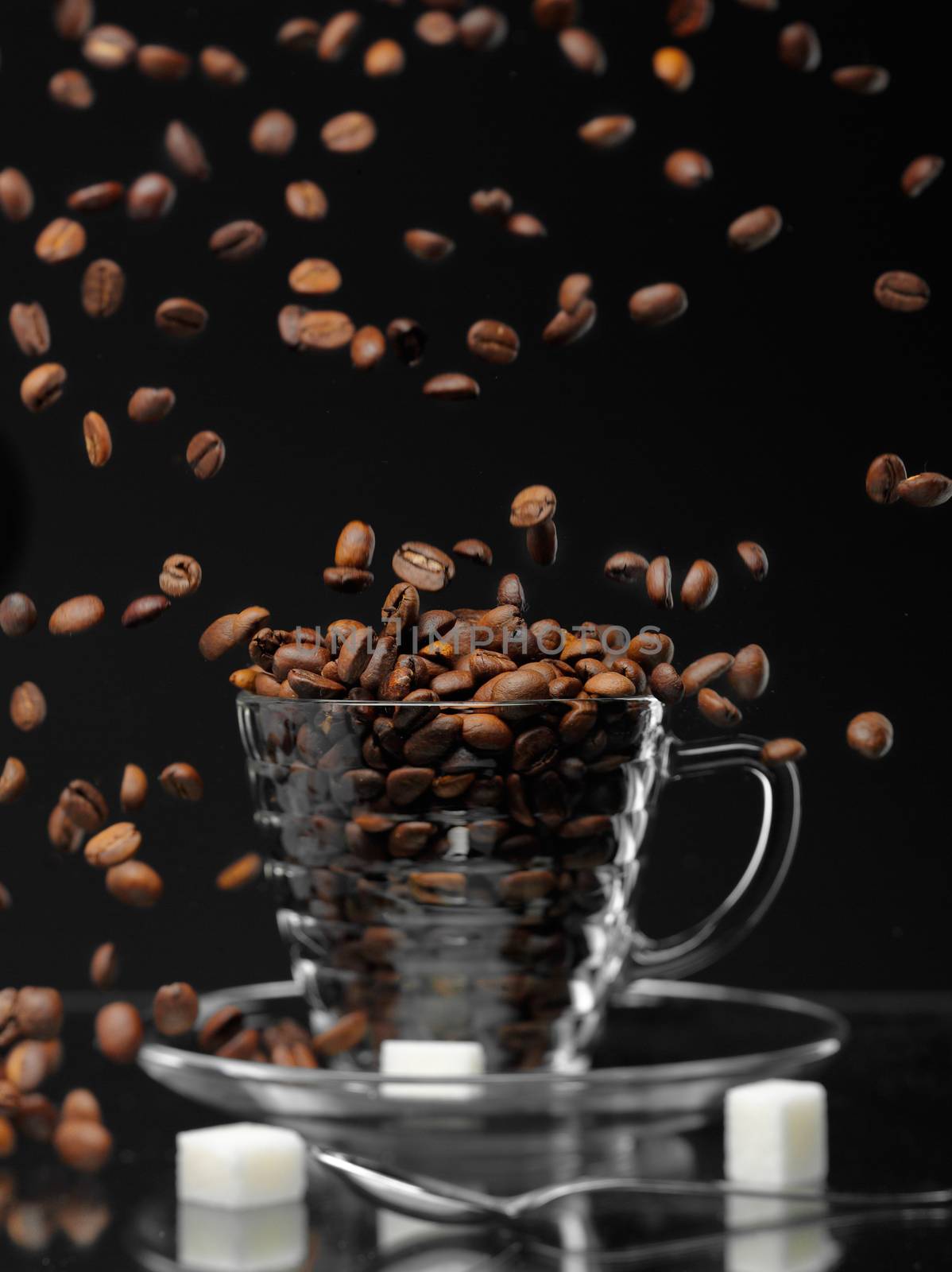 coffe beans are falling down to the cup