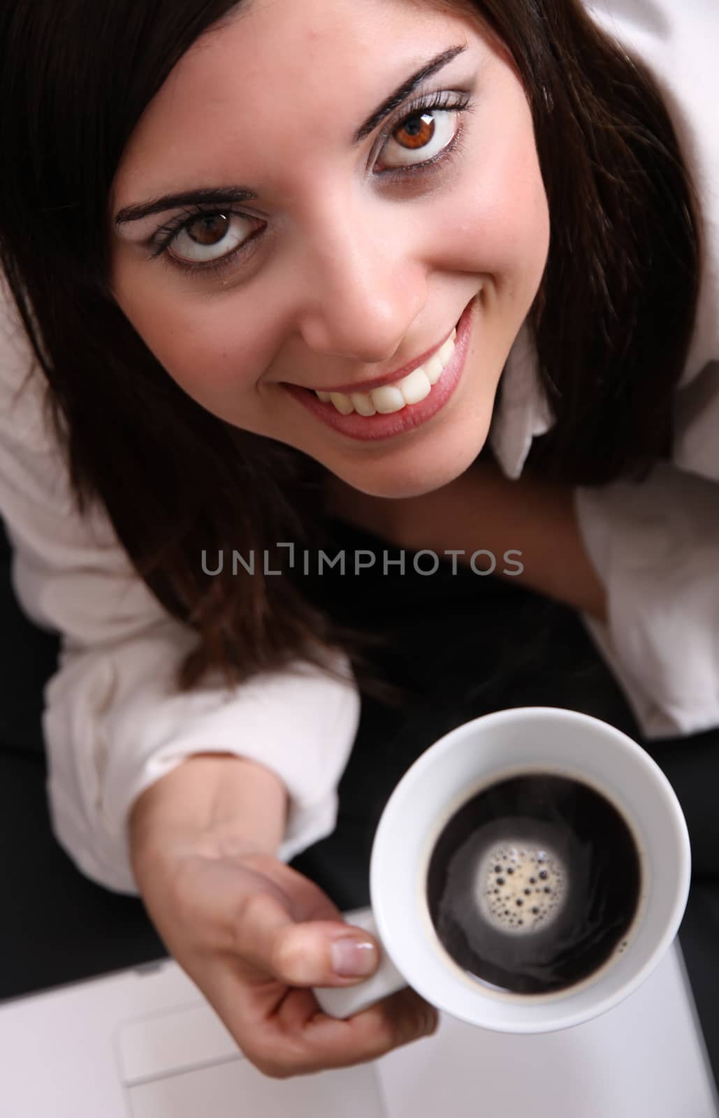 Portrait of a Hispanic young woman holding a cup of coffee.