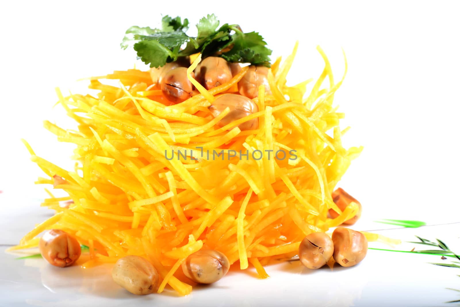 Chinese Food: Salad made of pumpkin slices and peanut kernels on a white background