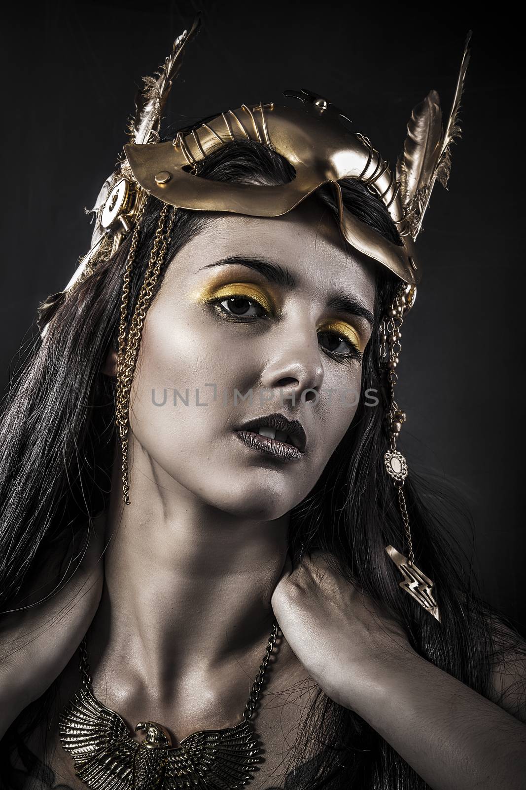 Sensual young woman with golden mask jewelry