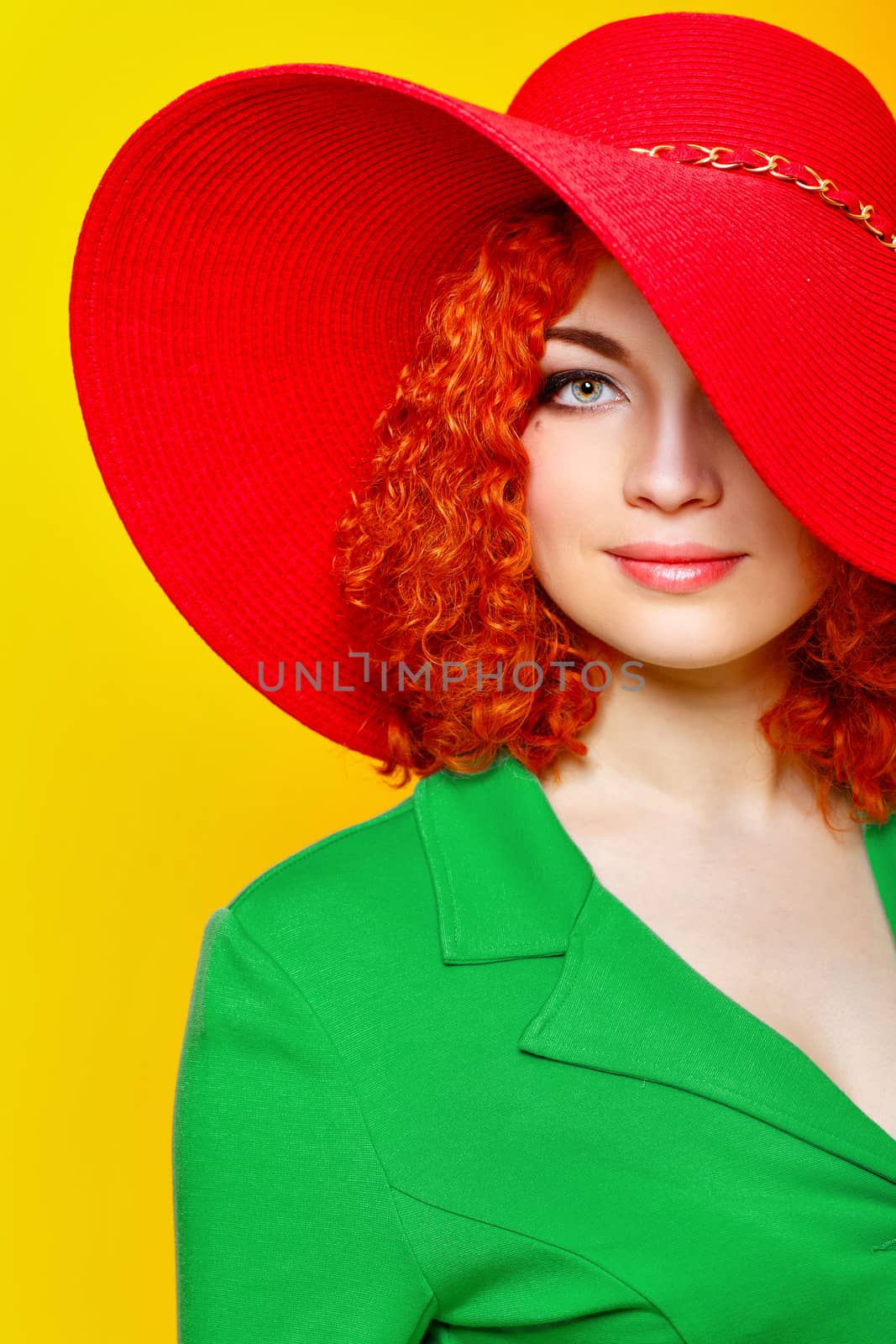 Attractive red-haired girl in red shady hat shot closeup