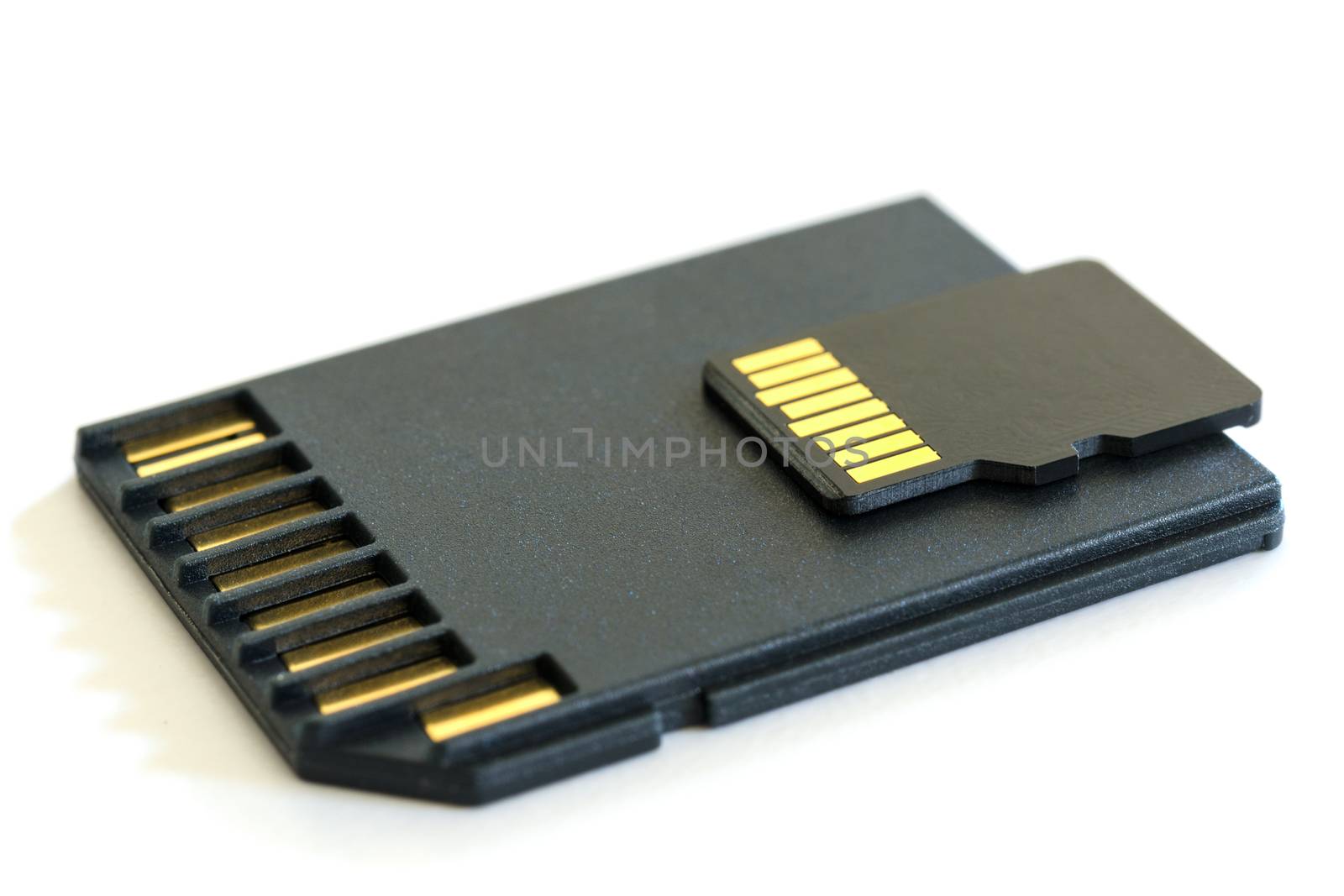 Black microSD memory card and SD card adapter isolated on white with shadow