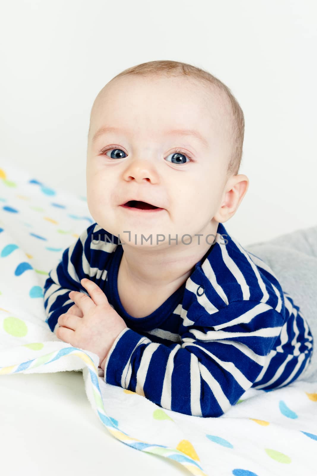 Funny cute blue-eyed baby. Little happy boy