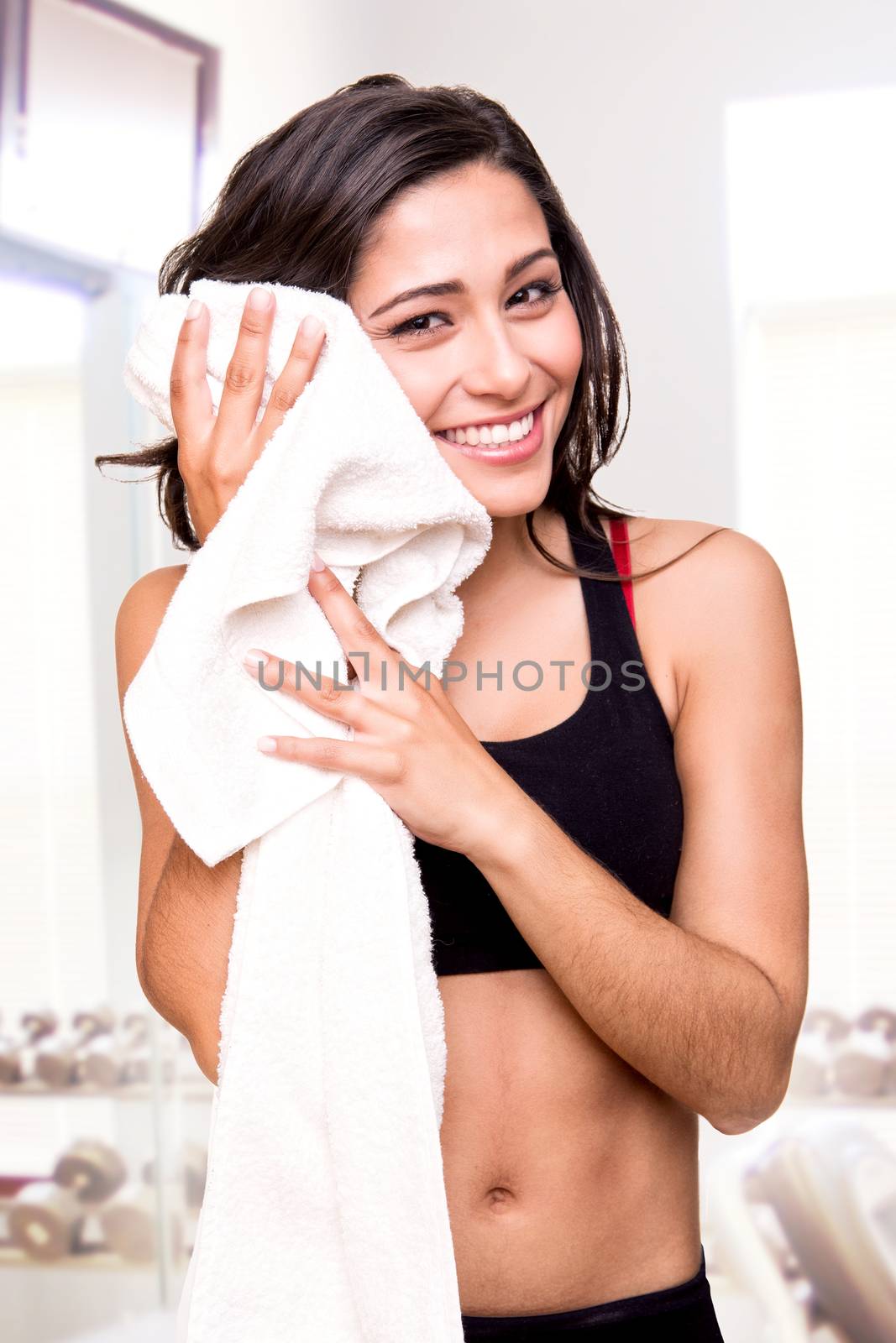 Fitness woman wiping sweat with a towel