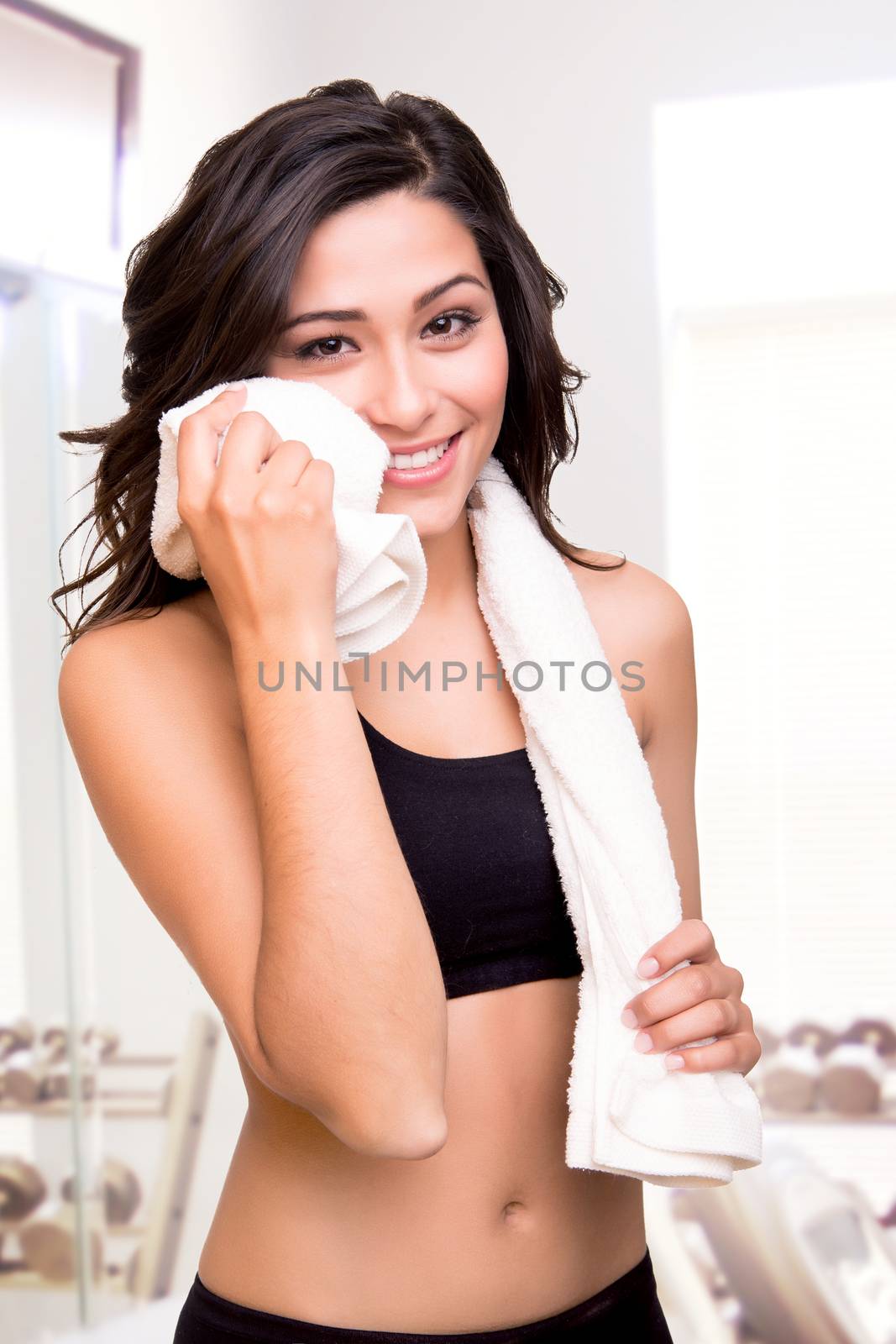 Fitness woman wiping sweat with a towel