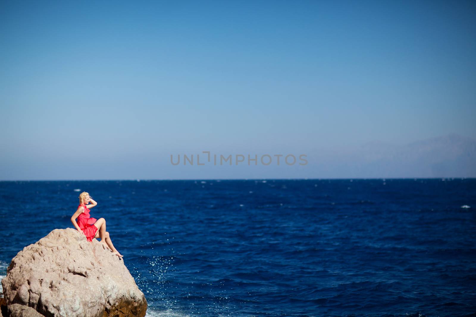 girl on the rock in the sea by vsurkov