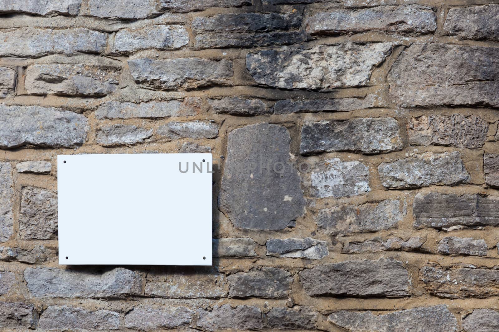 Blank sign on a slate wall