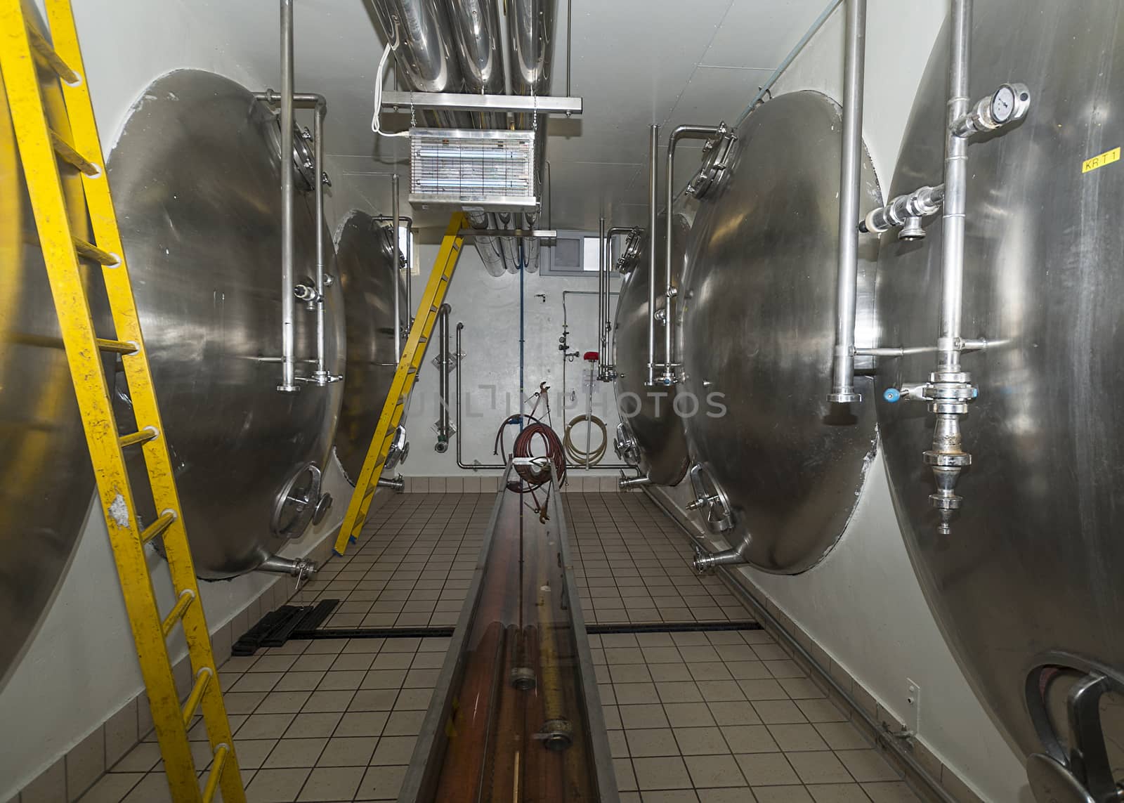 Horizontal lagering tanks in brewery. by Claudine