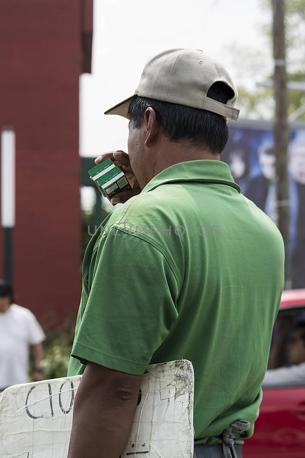 Person of scarce economic resources selling chewing gum on the street