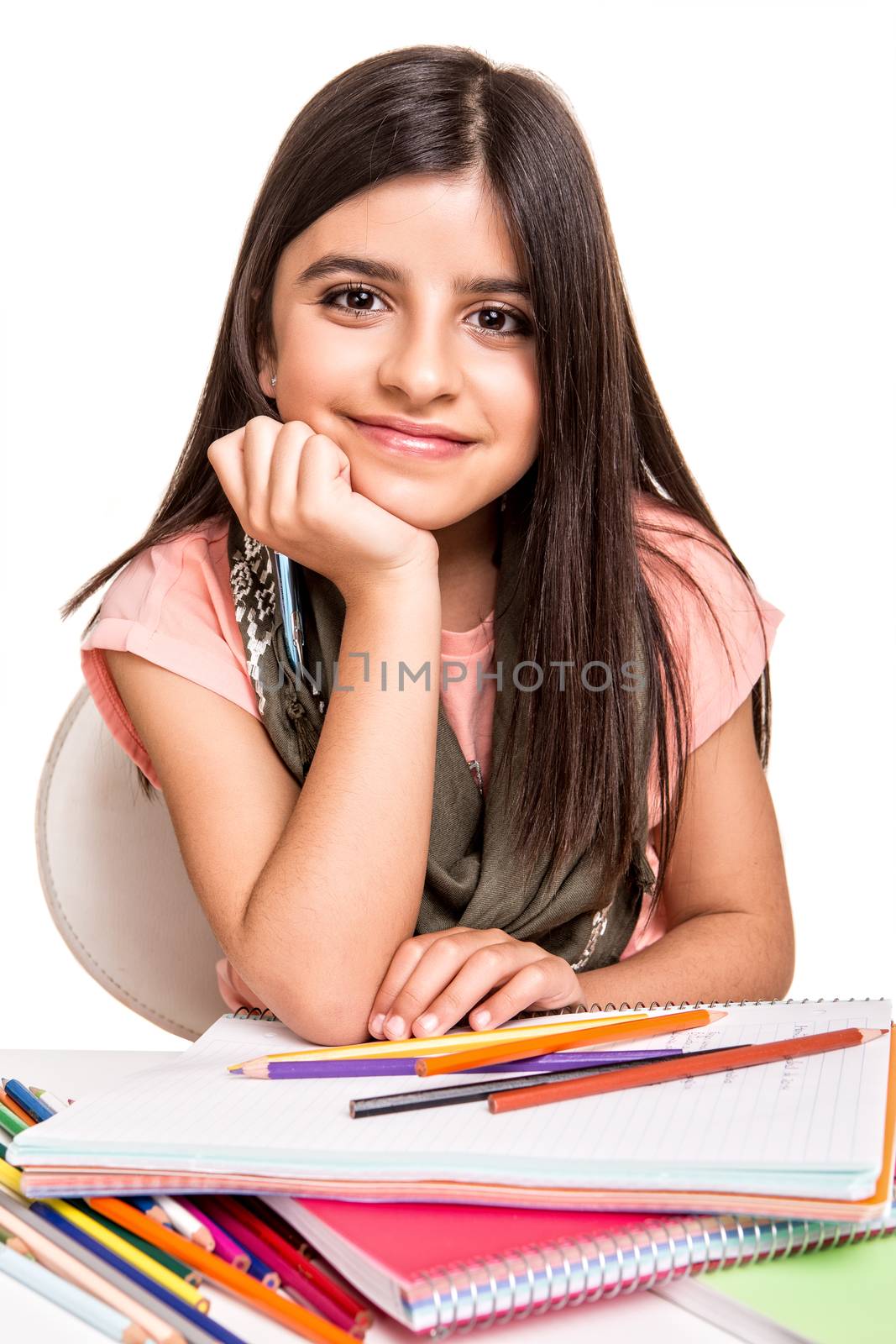 Cute little girl drawing with colorful pencils