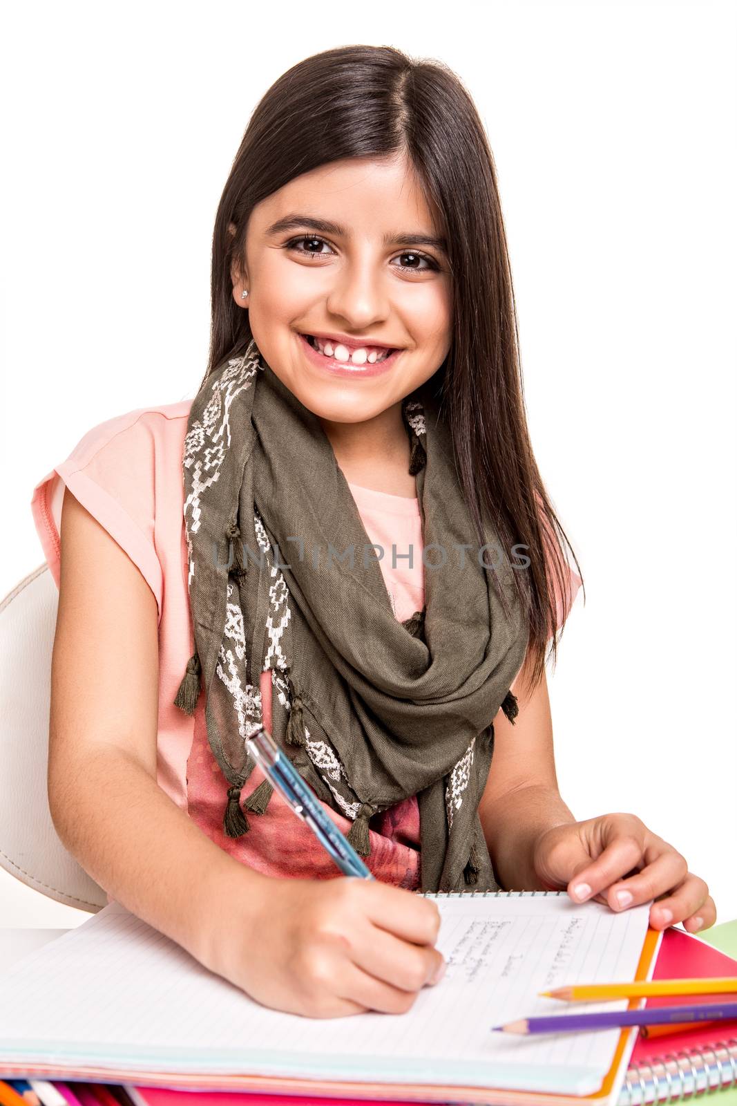 Cute little girl drawing with colorful pencils